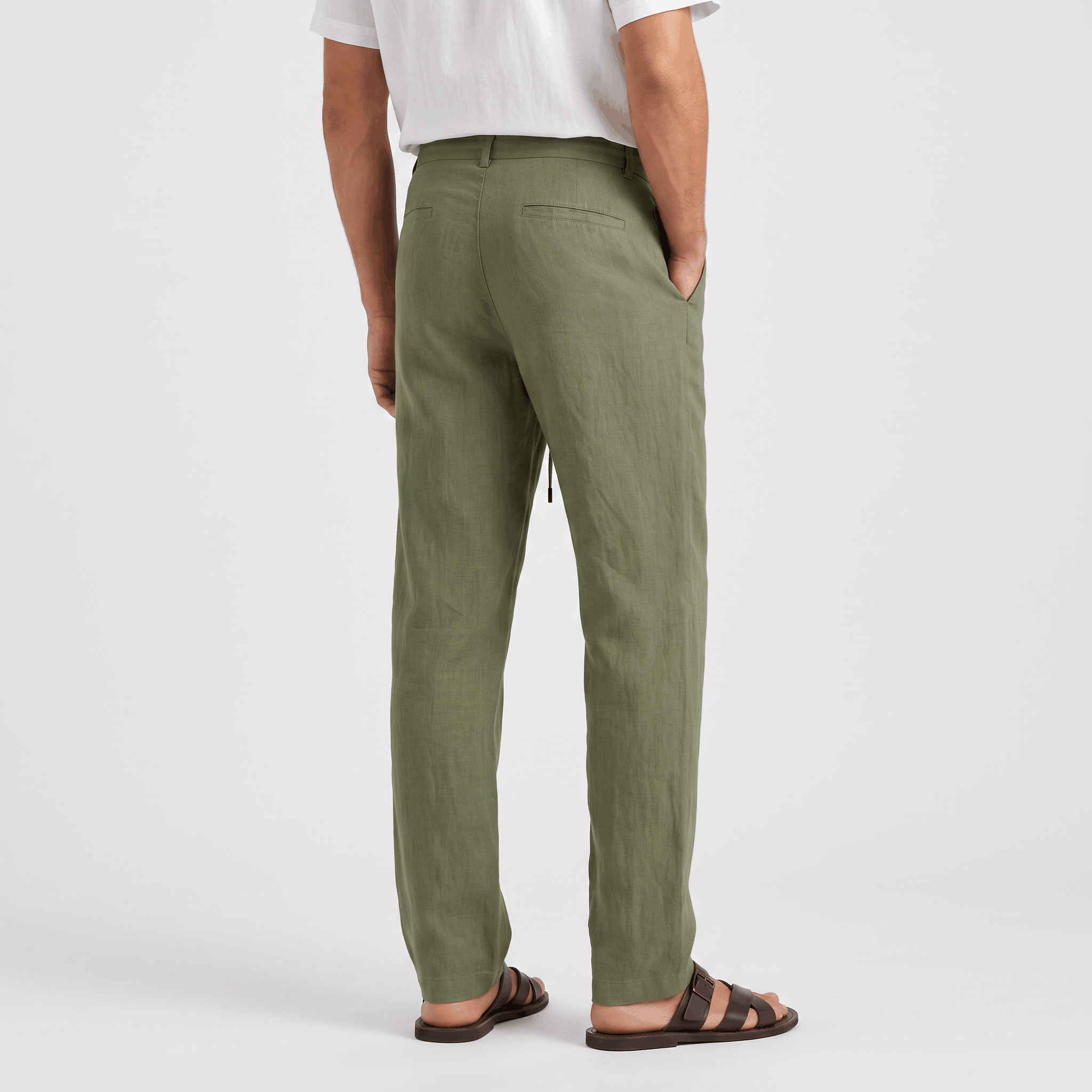 Back view of men's olive green linen drawstring pants with a straight-leg silhouette and elastic waistband.