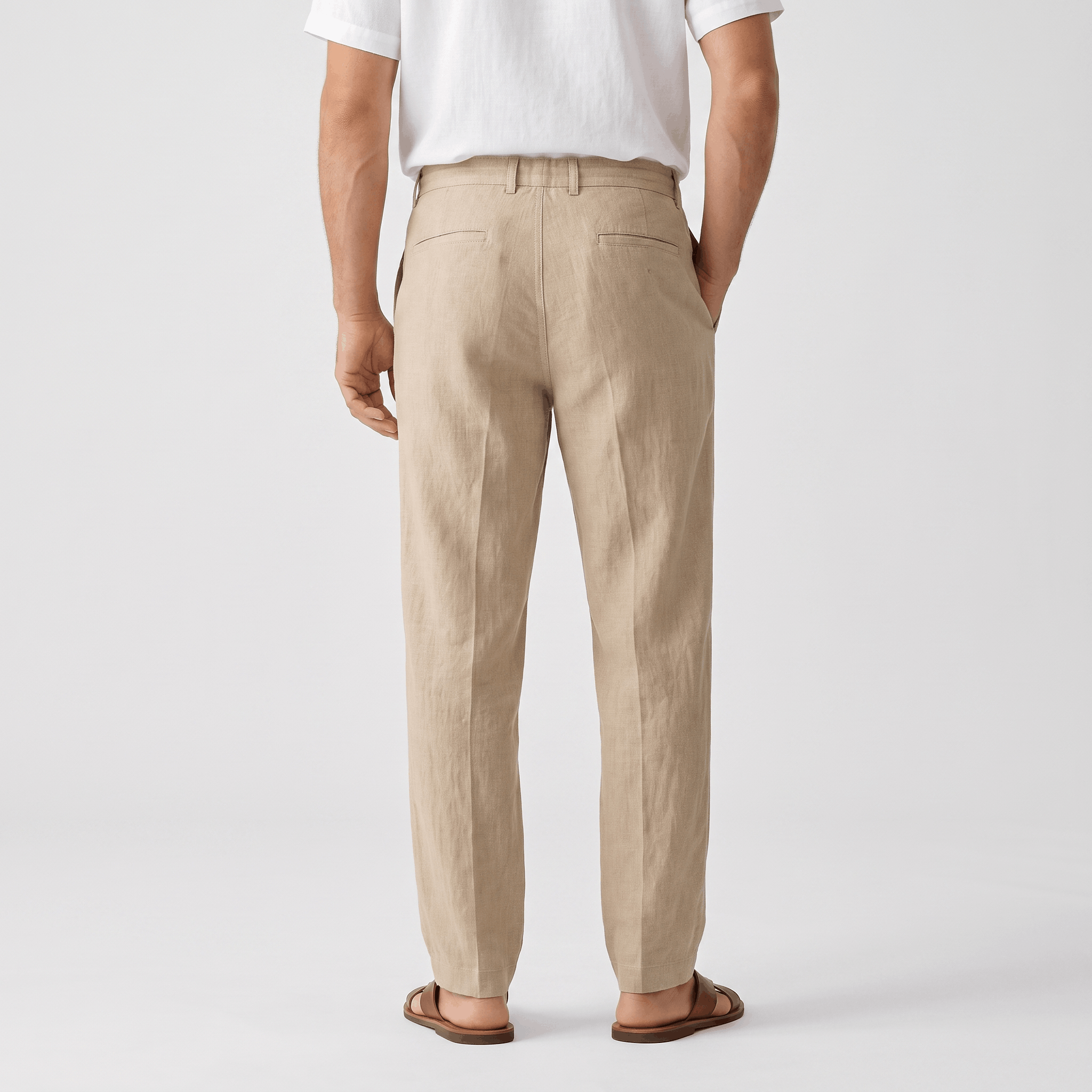 Back view of men's beige linen drawstring pants with an elastic waistband and relaxed straight-leg fit.