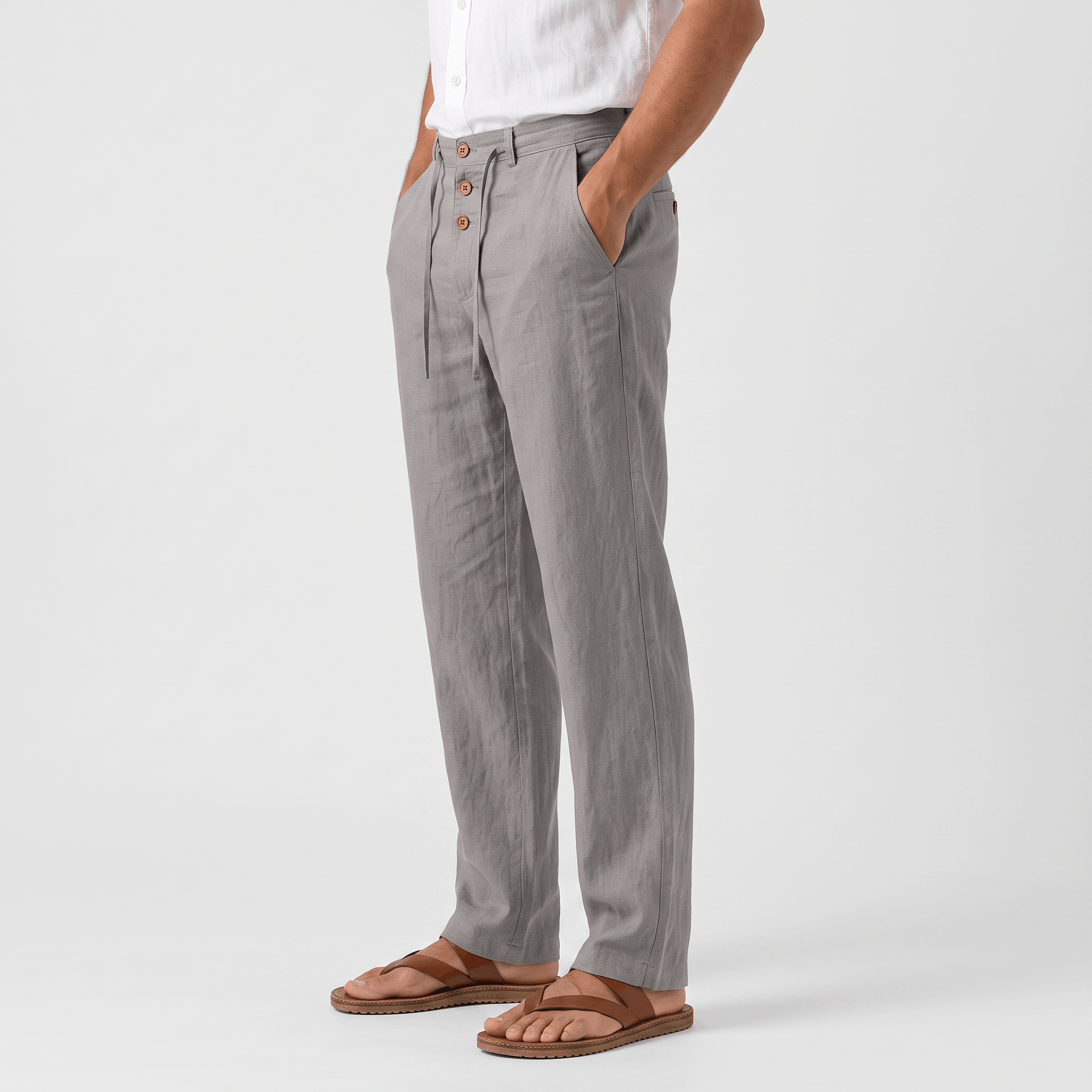 Side view of men's gray linen drawstring pants with a relaxed silhouette and lightweight linen construction.