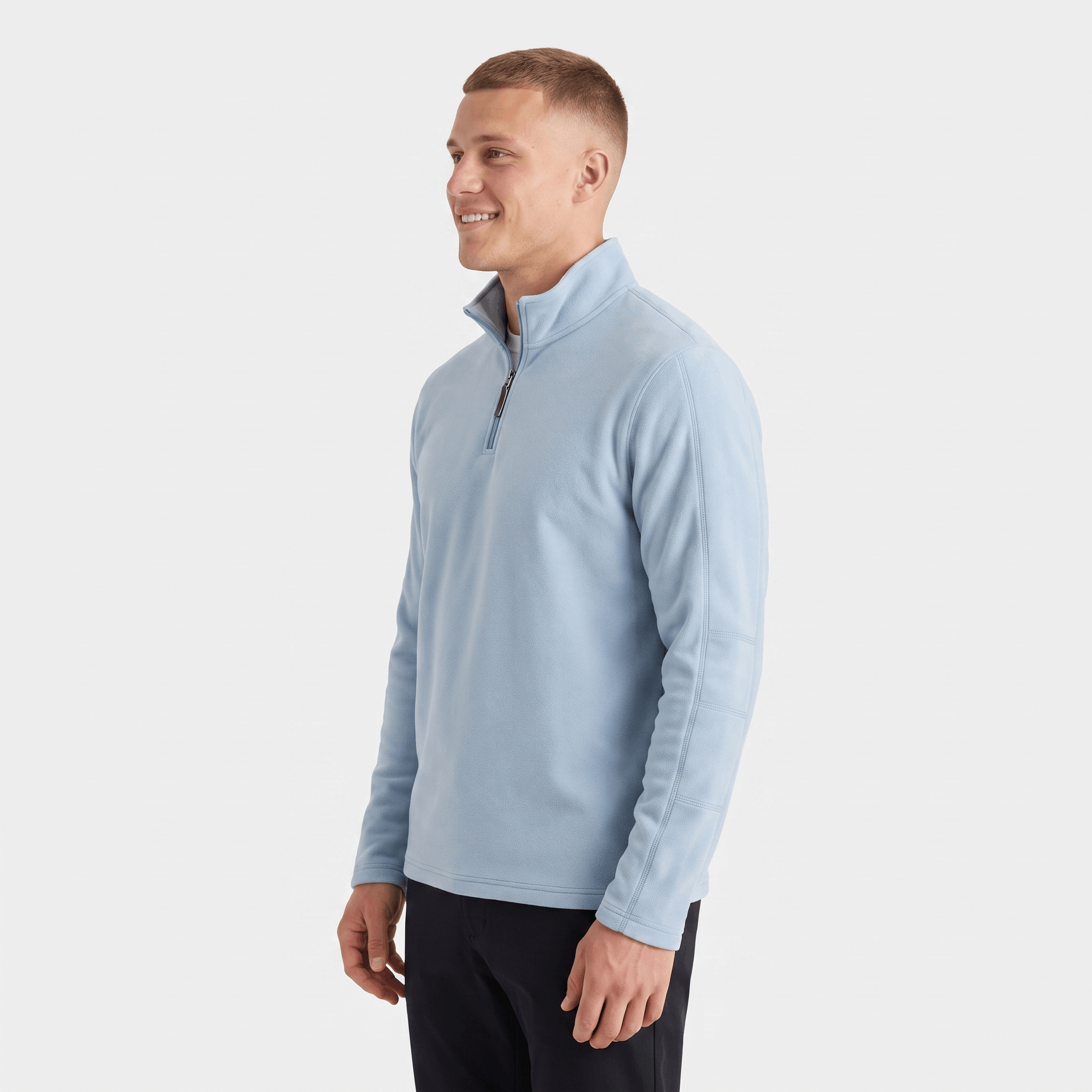 Side view of a man wearing a light blue quarter-zip sweater featuring a stand collar and long sleeves.