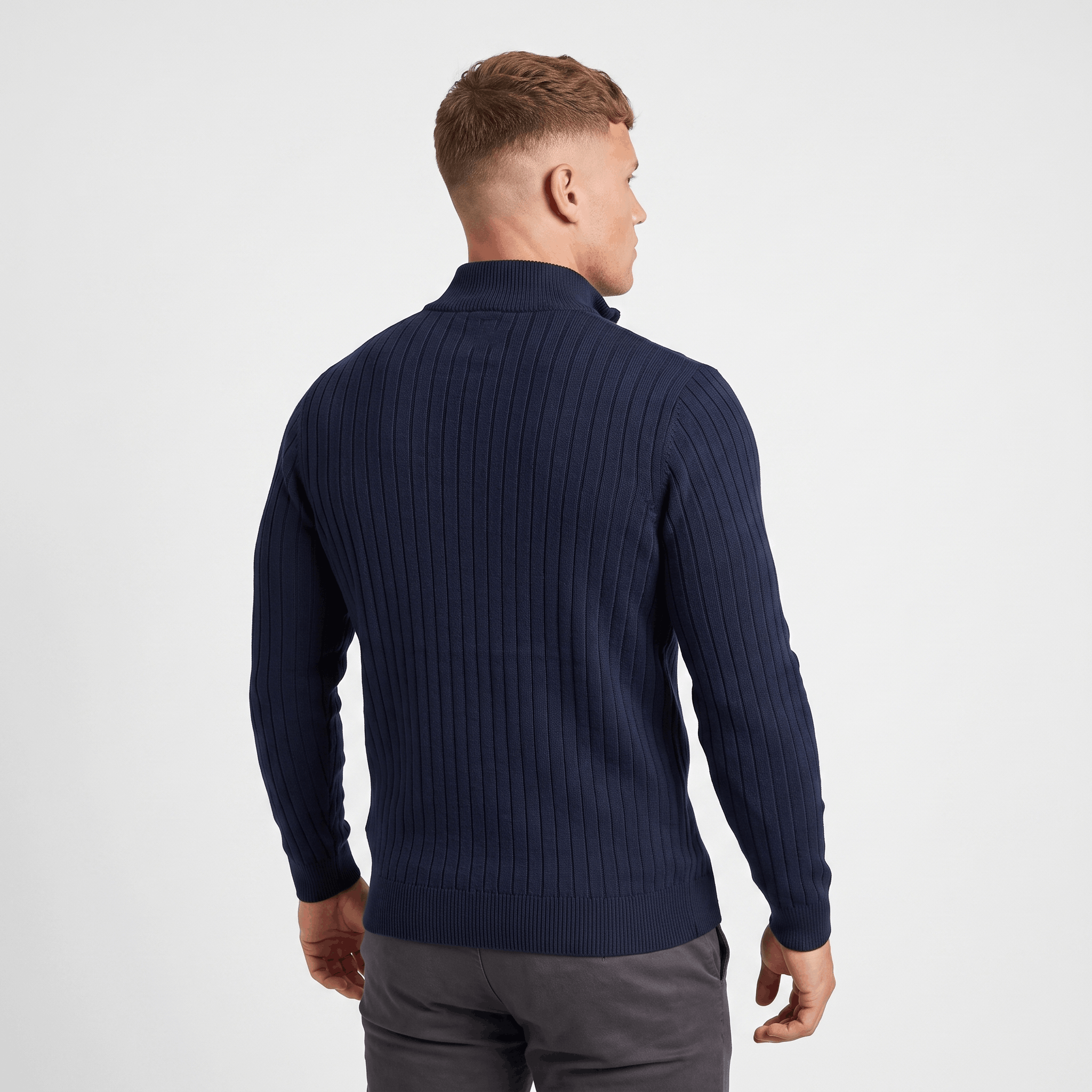 Back view of a men's navy ribbed quarter-zip knit sweater with a stand collar and ribbed texture.