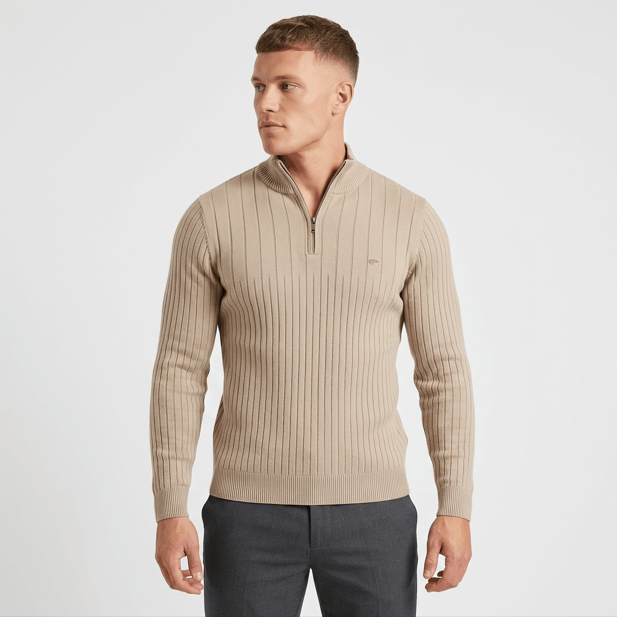 Side view of a man wearing a beige ribbed quarter-zip sweater featuring a stand collar and modern silhouette.