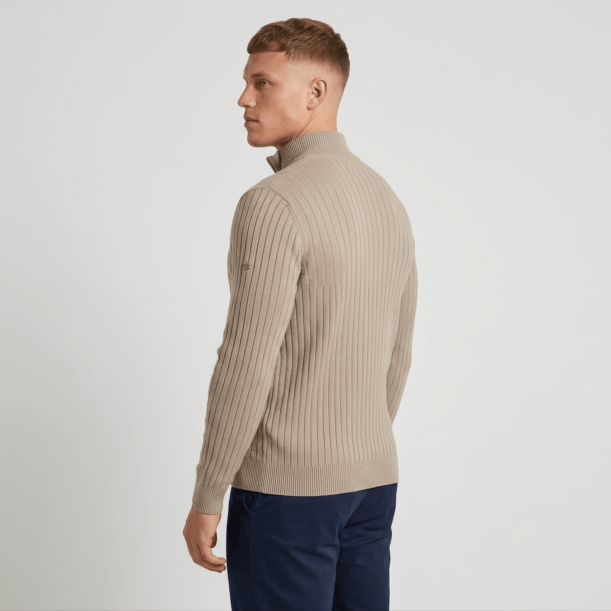 Man wearing a black ribbed quarter-zip knit sweater with a stand collar, long sleeves, and a slim fit.