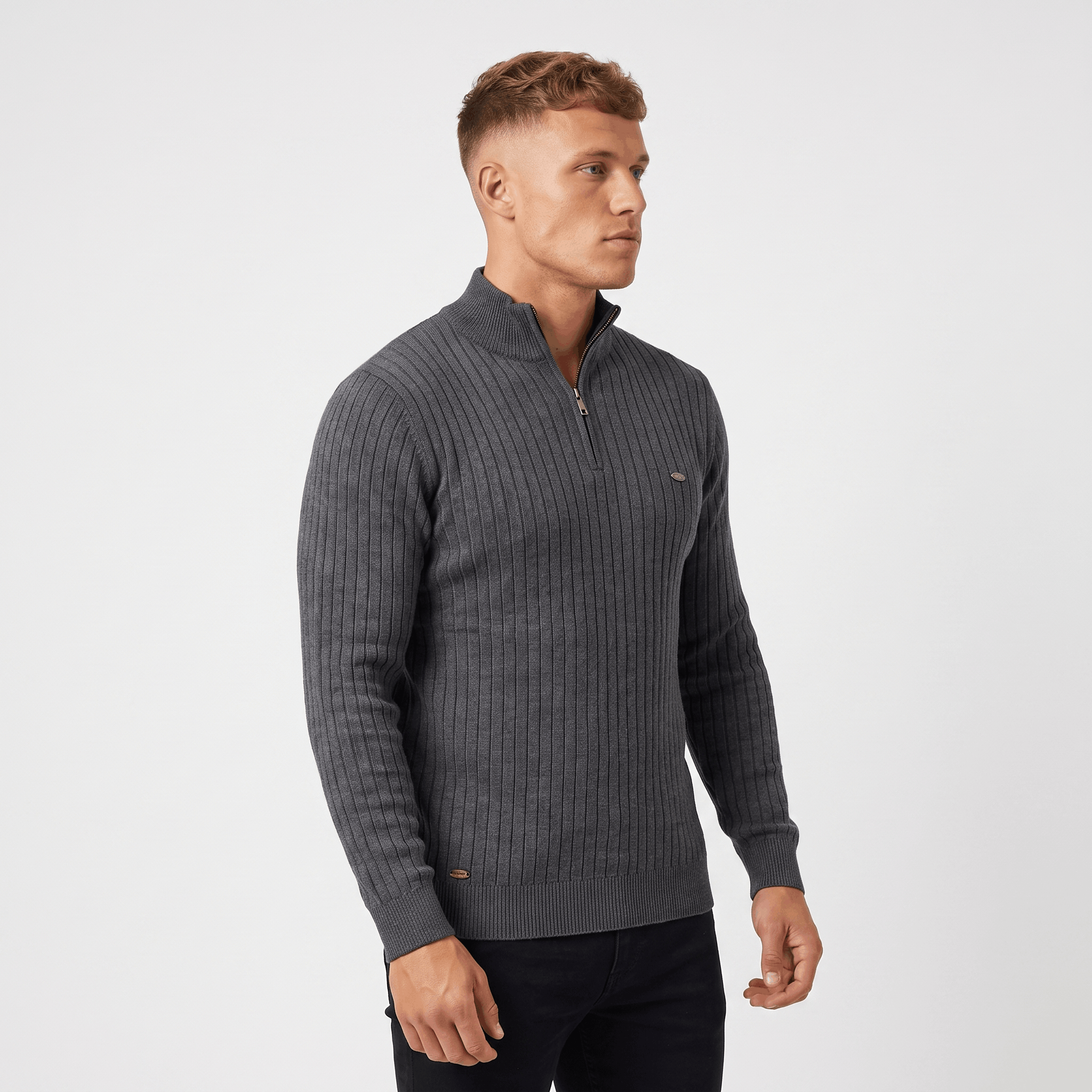 Side view of a man wearing a charcoal ribbed quarter-zip sweater with a stand collar and fitted silhouette.