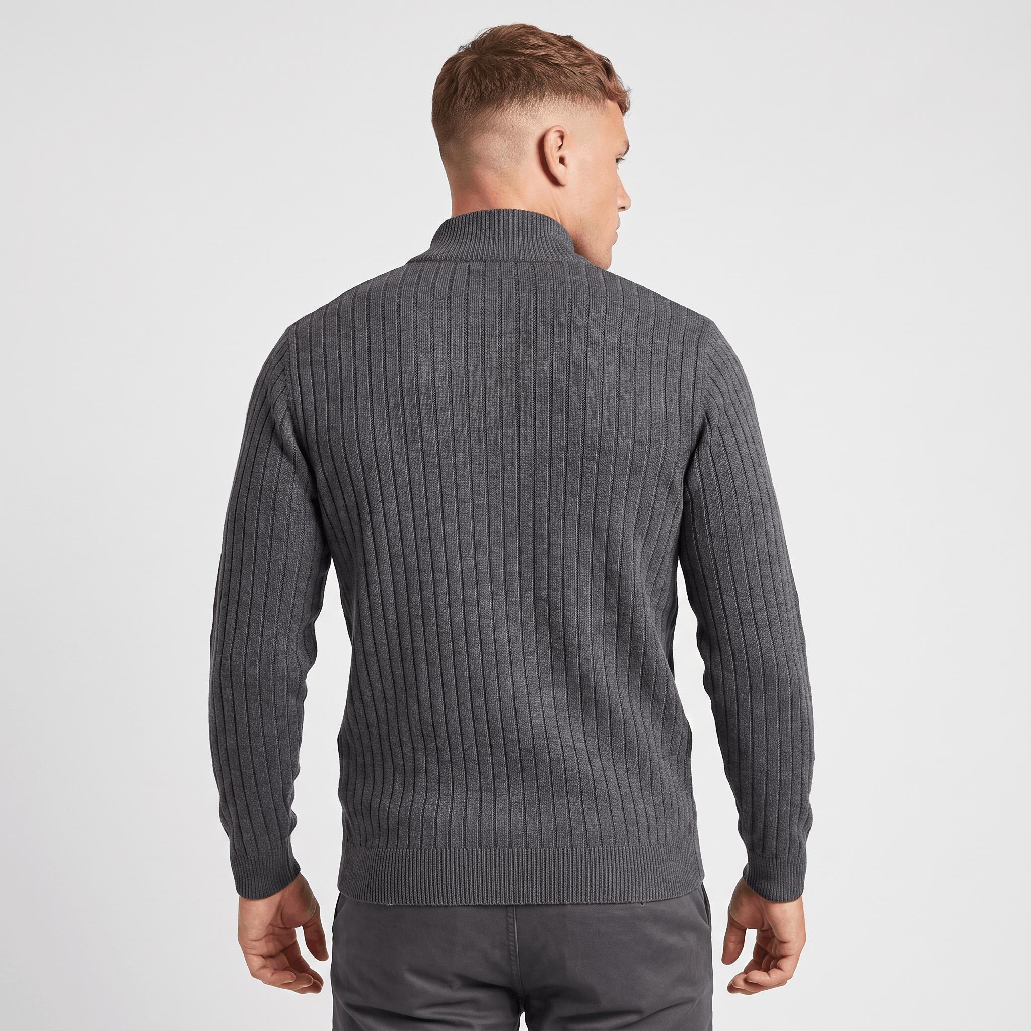 Back view of a men's charcoal ribbed quarter-zip knit sweater with a stand collar and vertical ribbed texture.