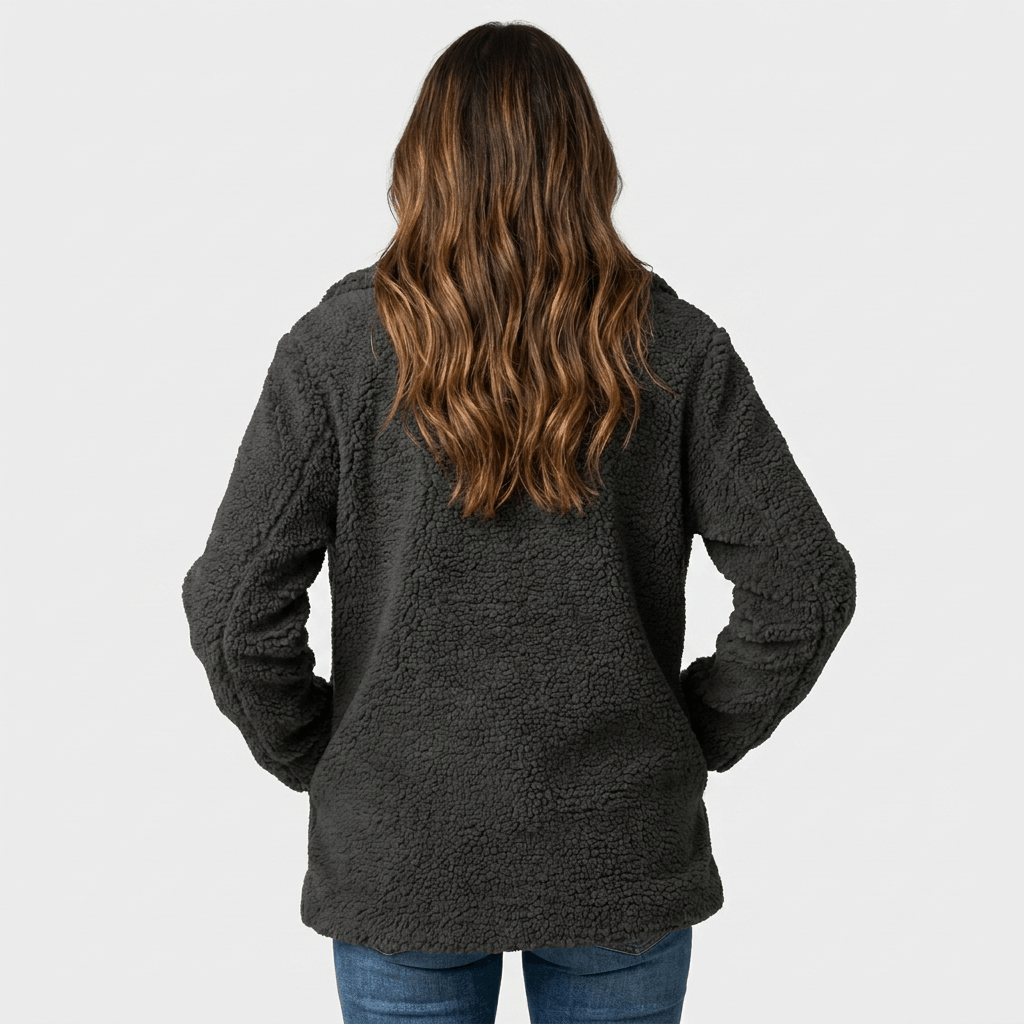 Back view of a woman wearing a dark gray textured coat with a structured silhouette and long sleeves.