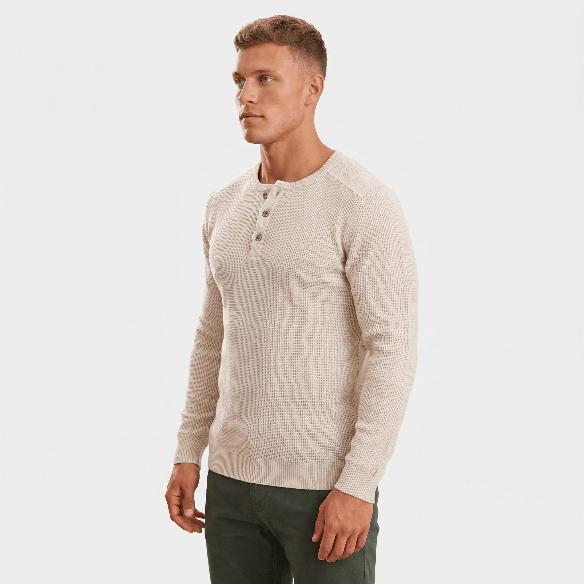Side view of a man wearing a cream waffle knit Henley sweater featuring a three-button neckline and textured knit fabric.