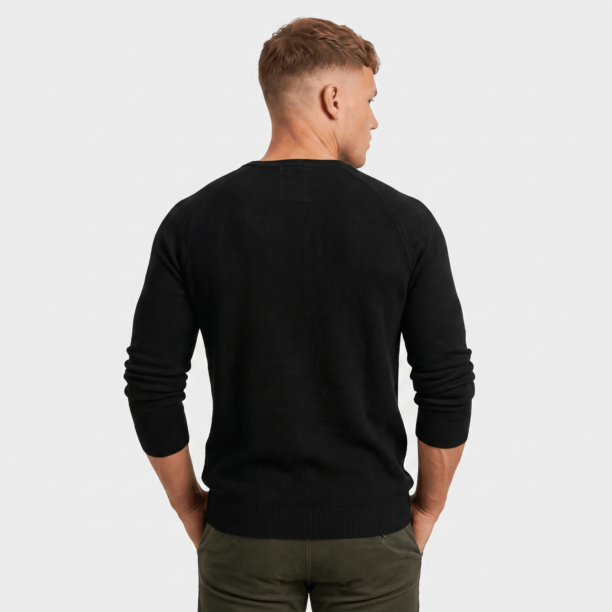 Back view of a men's black waffle knit Henley sweater with ribbed cuffs, hem, and a classic fit.