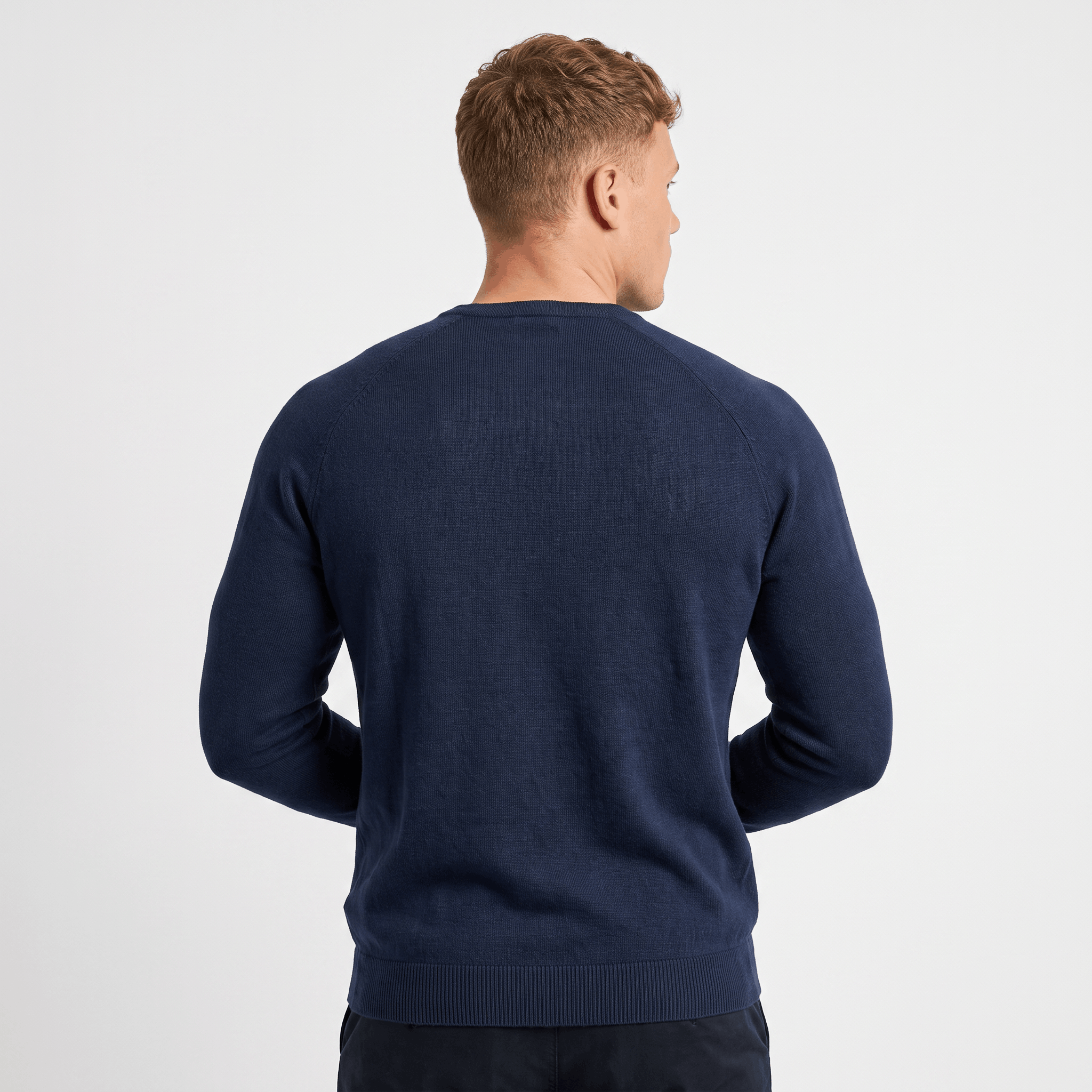 Back view of a men's navy waffle knit Henley sweater with textured knit fabric and ribbed trim.