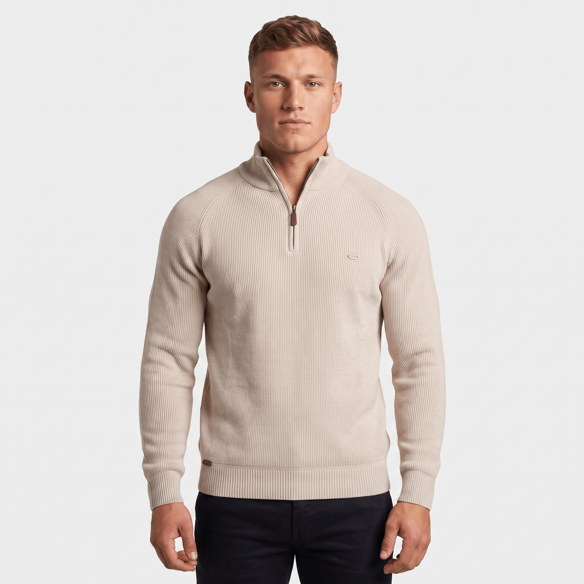 Man wearing a cream ribbed quarter-zip knit sweater with a stand collar, long sleeves, and a modern fit.