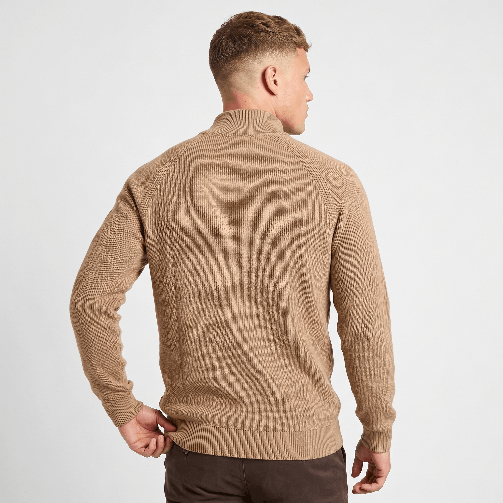 Back view of a men's camel ribbed quarter-zip knit sweater featuring a stand collar and fitted silhouette.