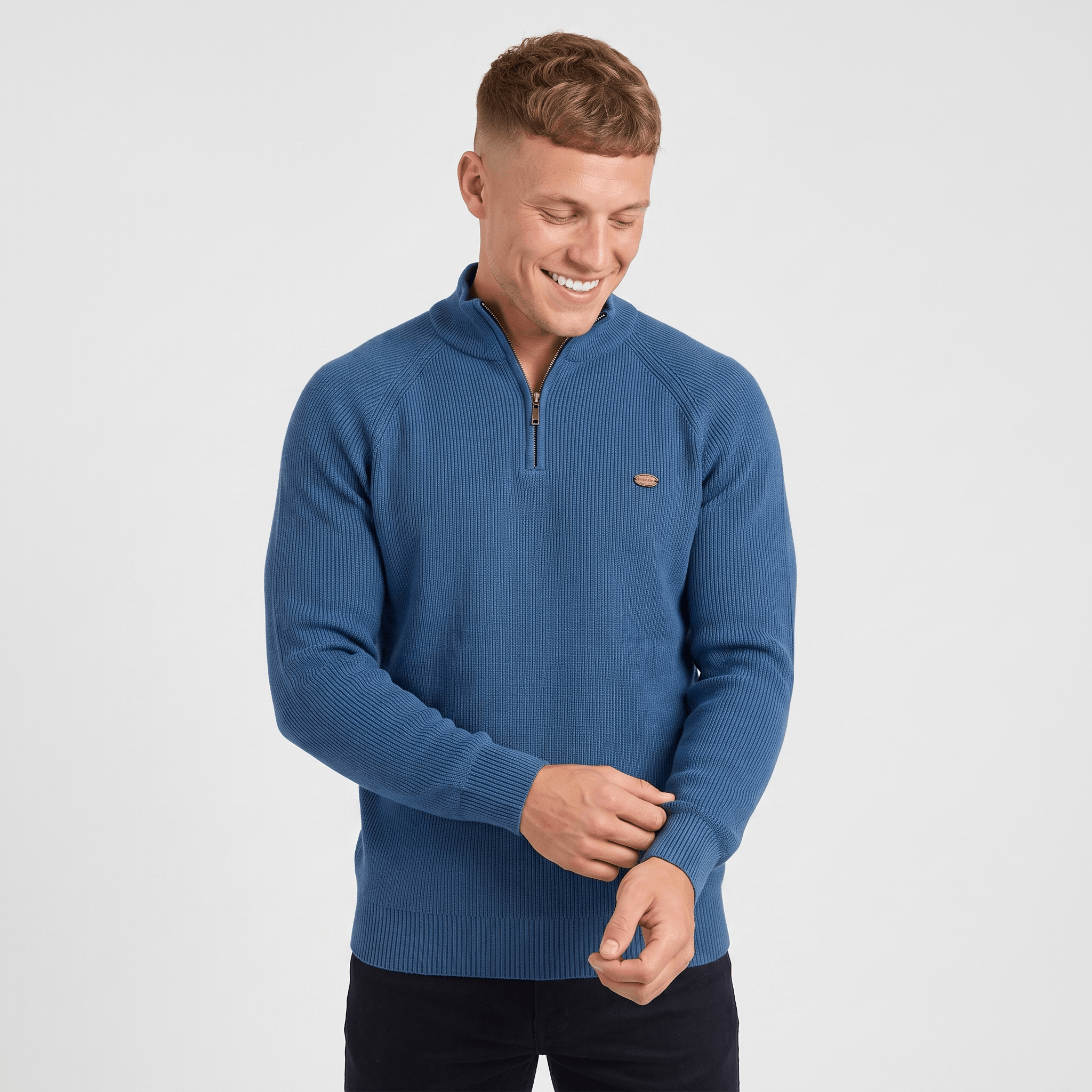 Man wearing a blue ribbed quarter-zip knit sweater with a stand collar, long sleeves, and a modern slim fit.
