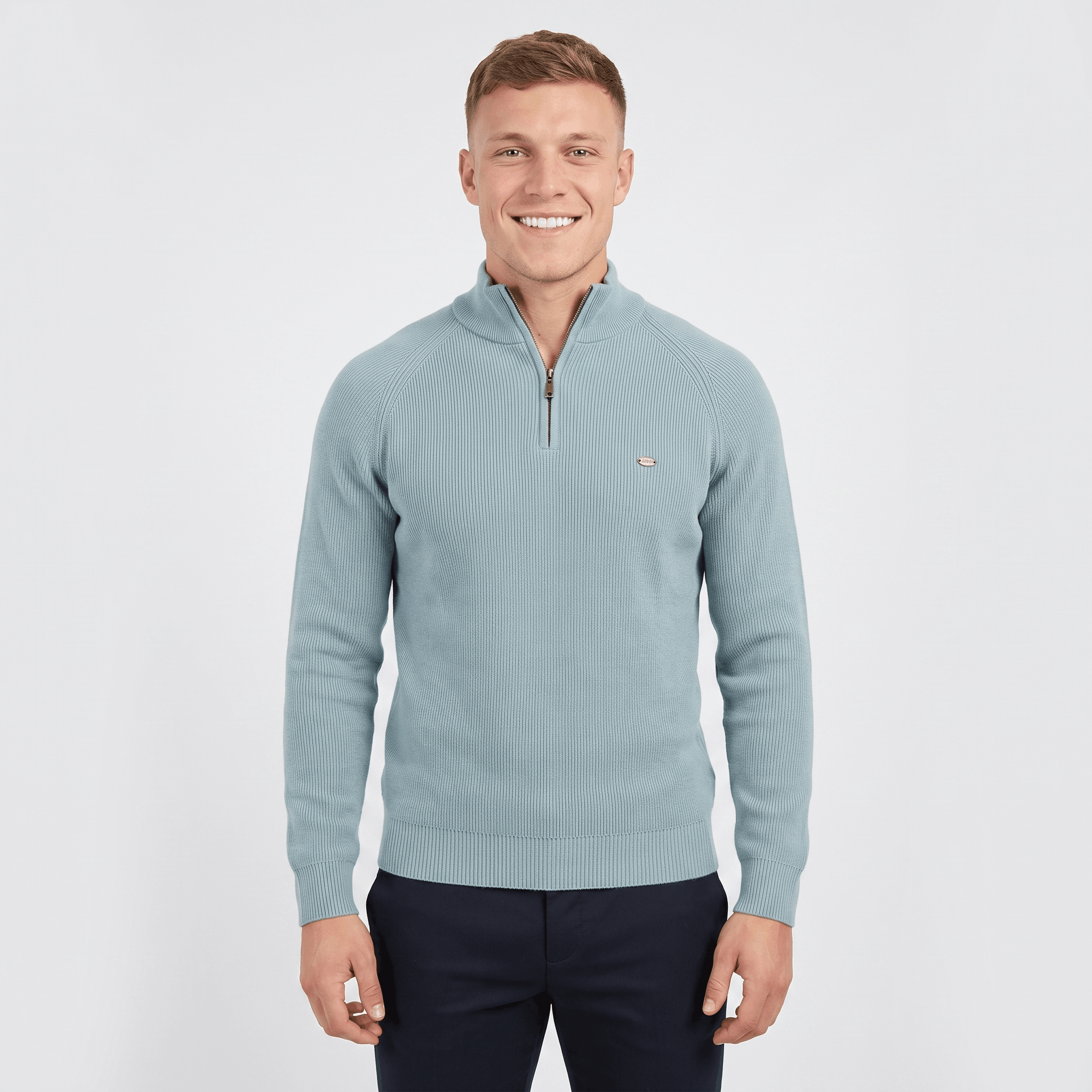 Man wearing a light blue ribbed quarter-zip knit sweater with a stand collar, long sleeves, and a modern slim fit.