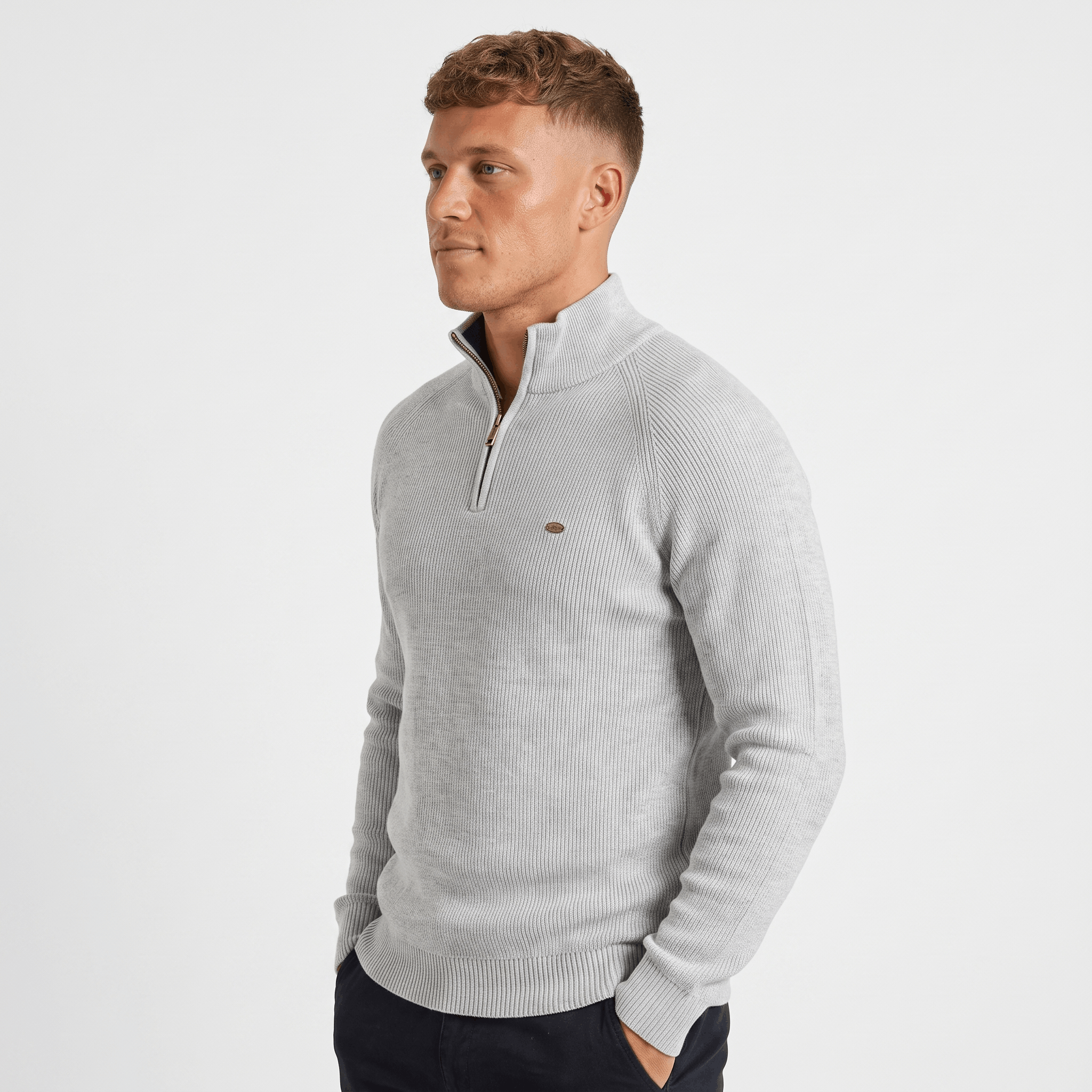 Side view of a man wearing a light gray ribbed quarter-zip sweater featuring a stand collar and fitted silhouette.