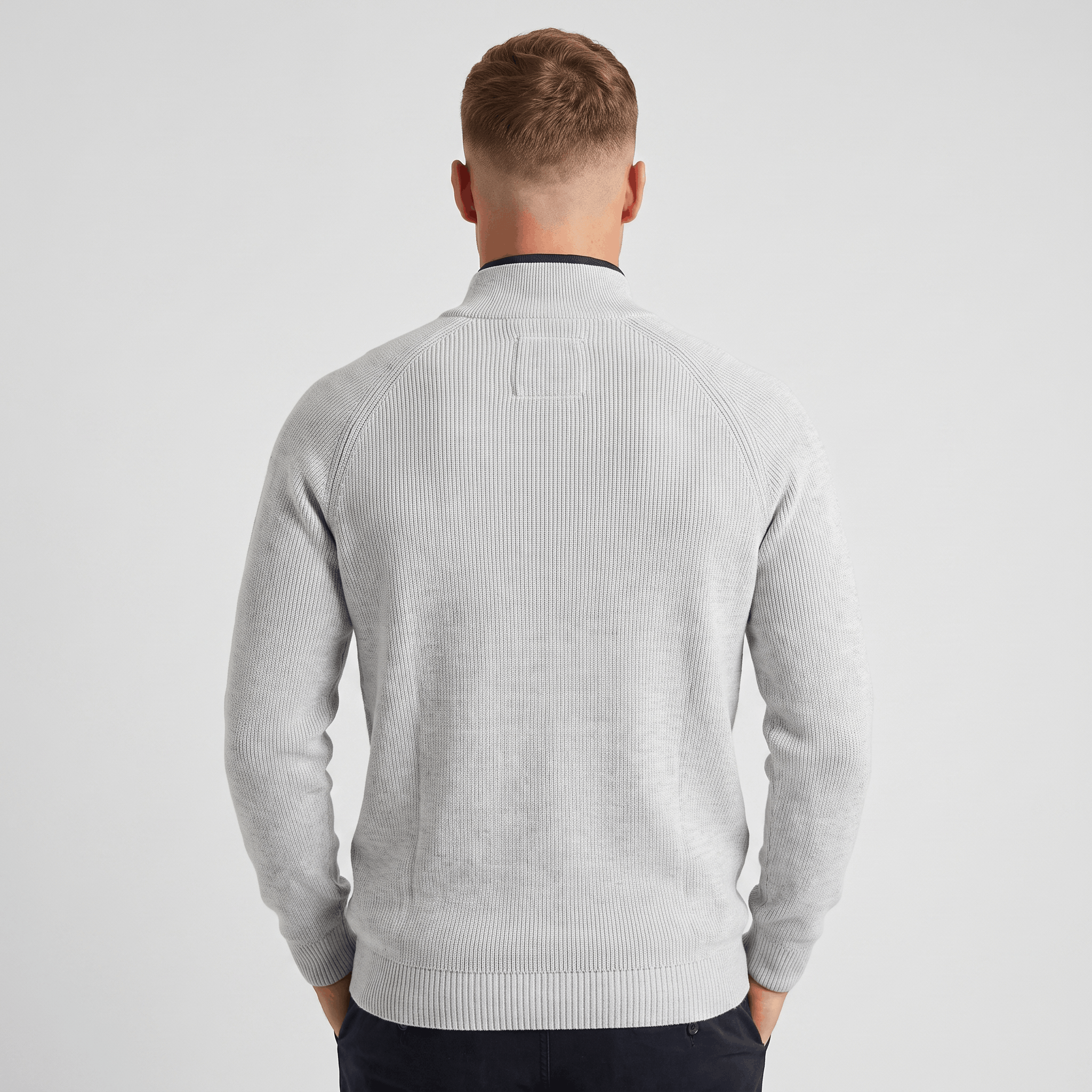 Back view of a men's light gray ribbed quarter-zip knit sweater with a stand collar and vertical ribbed texture.