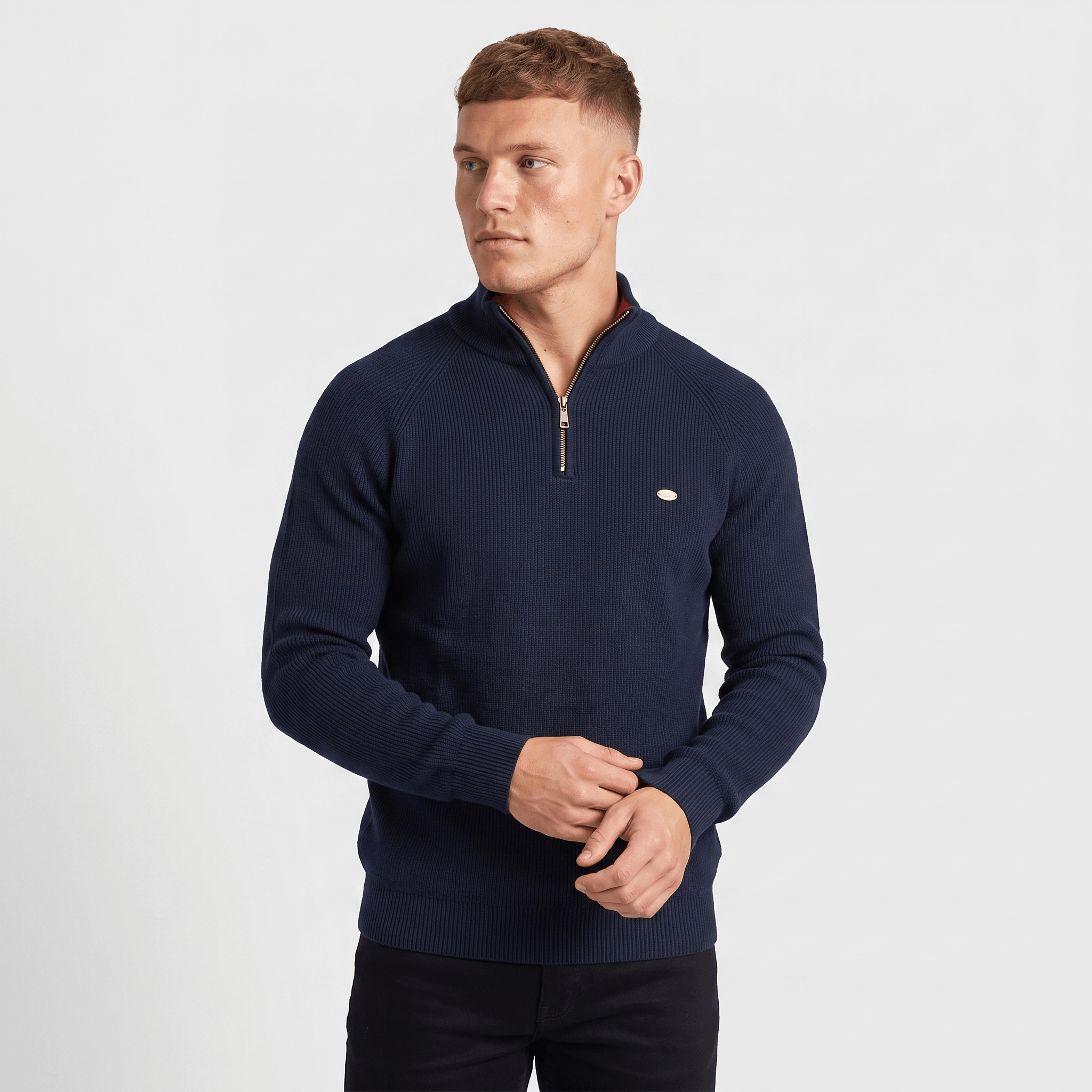 Man wearing a navy ribbed quarter-zip knit sweater with a stand collar, long sleeves, and a tailored fit.