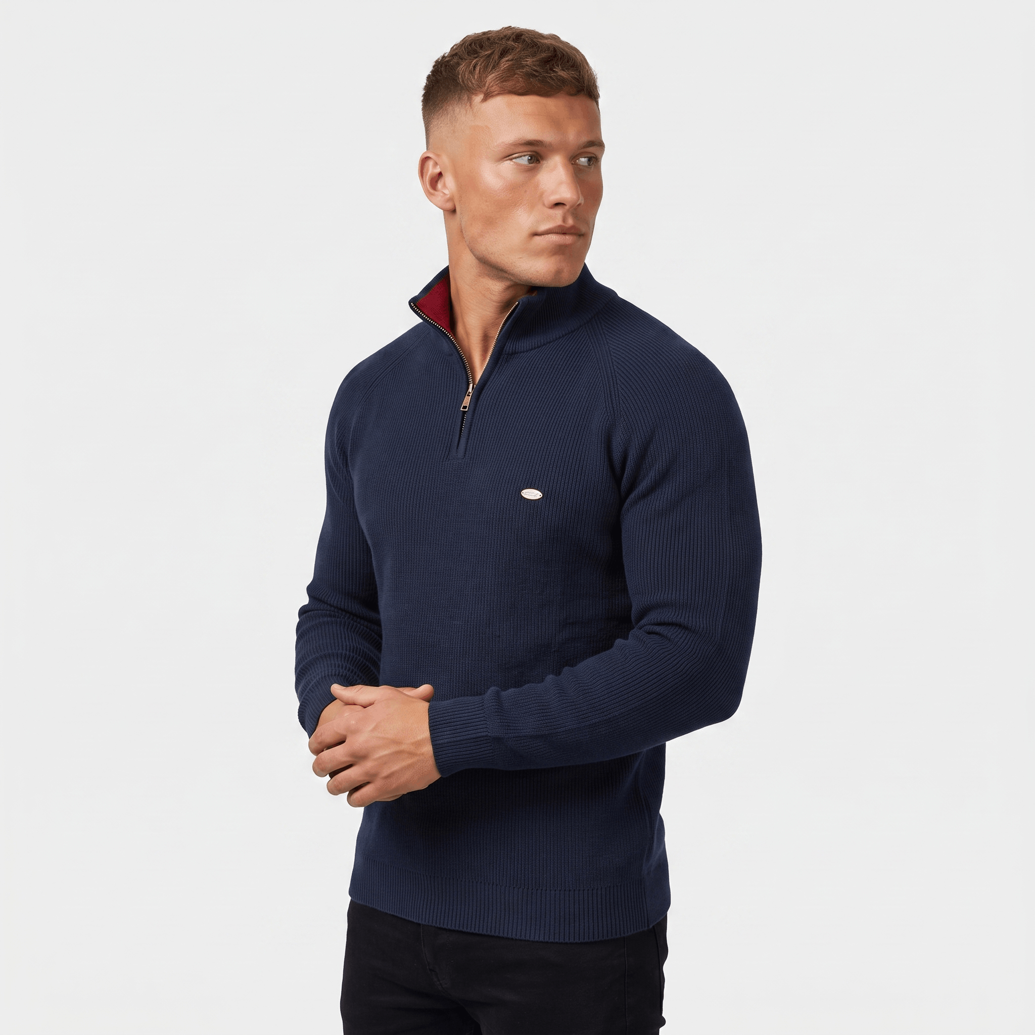 Side view of a man wearing a navy ribbed quarter-zip sweater with a stand collar and modern silhouette.