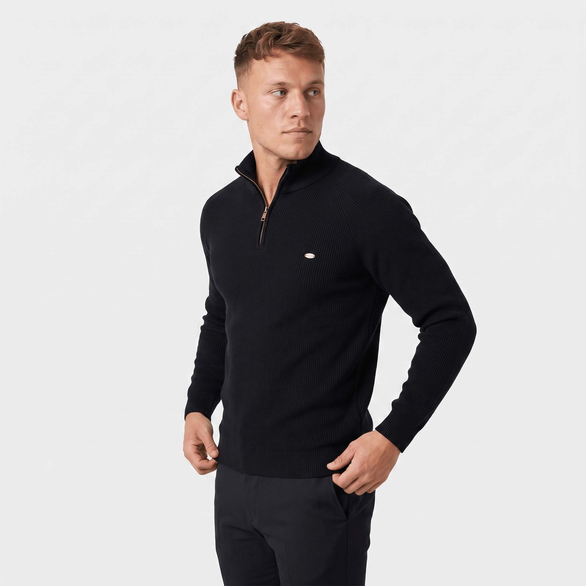 Side view of a man wearing a black ribbed quarter-zip sweater with a stand collar and fitted silhouette.