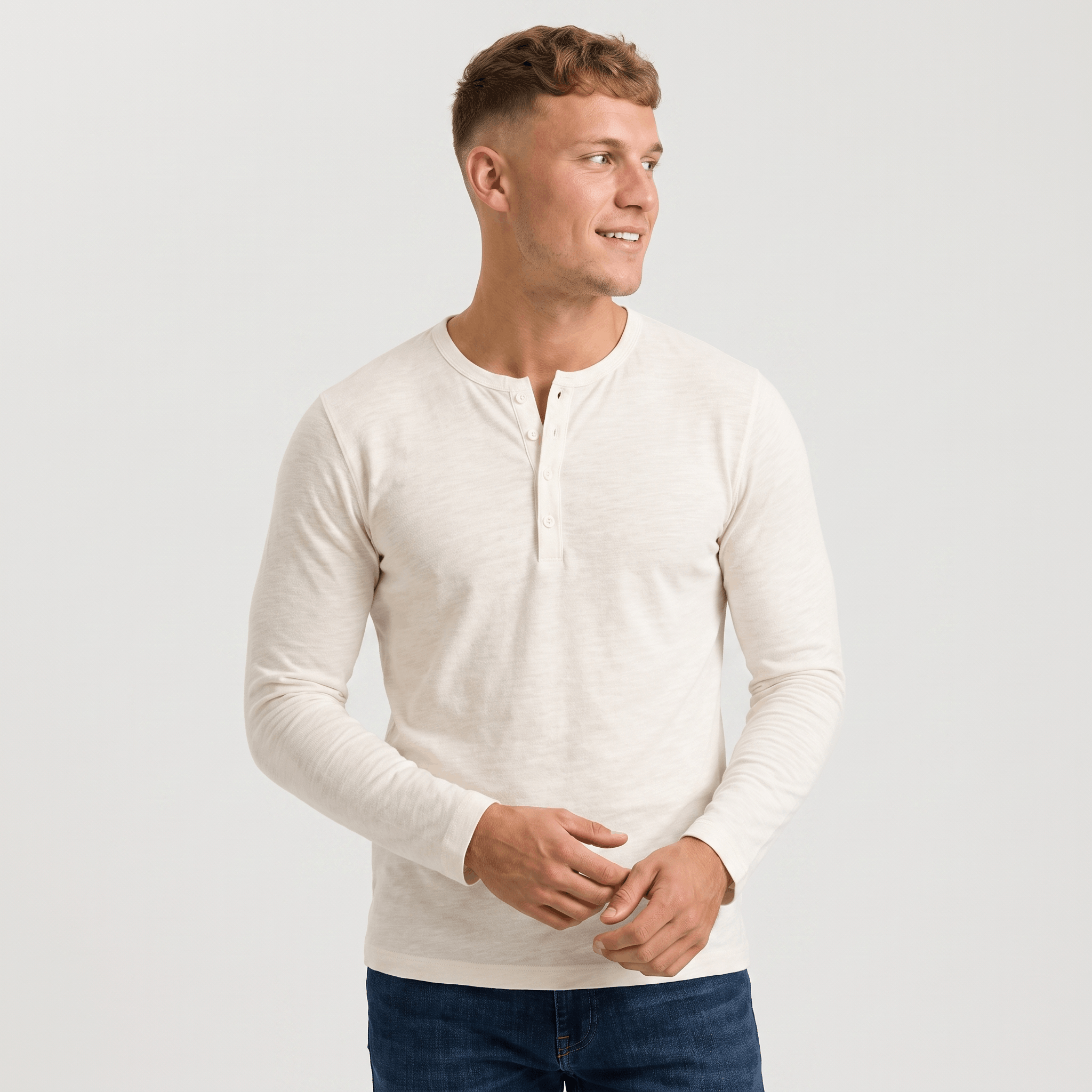 Man wearing a white long-sleeve Henley shirt with a three-button placket, crew neckline, and modern slim fit.