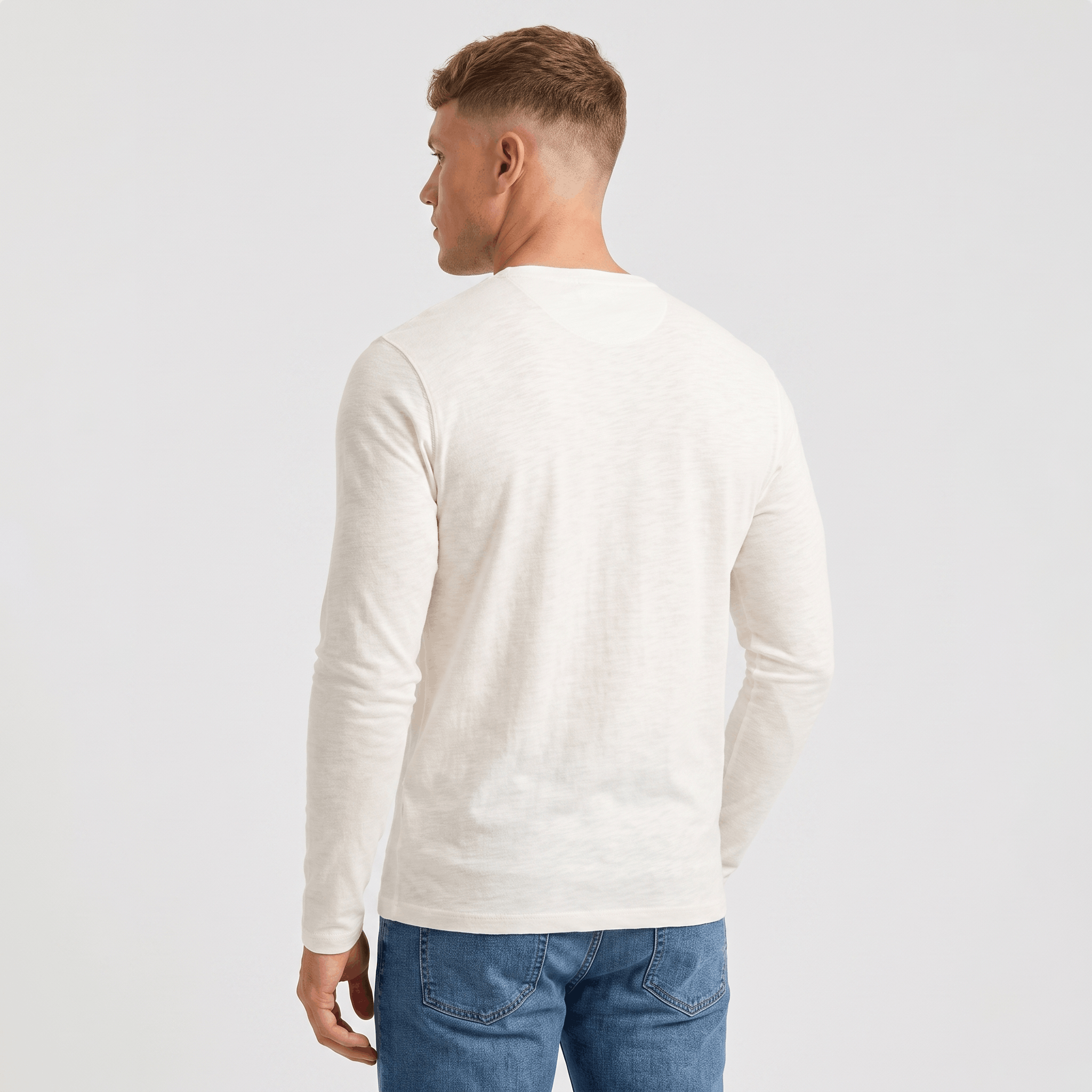 Back view of a men's white long-sleeve Henley shirt featuring a classic fit and long sleeves.