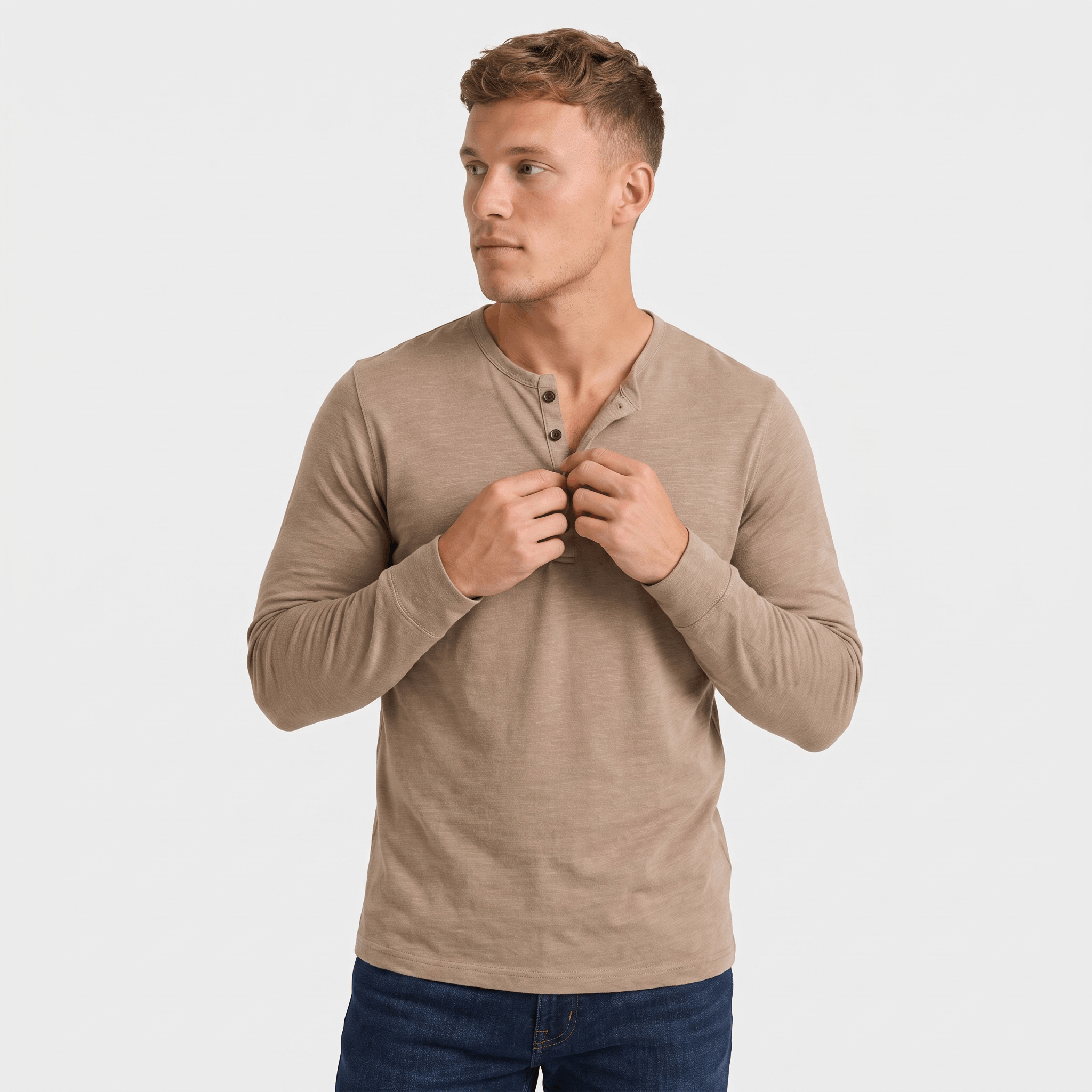 Man wearing a taupe long-sleeve Henley shirt with a three-button placket, crew neckline, and tailored fit.