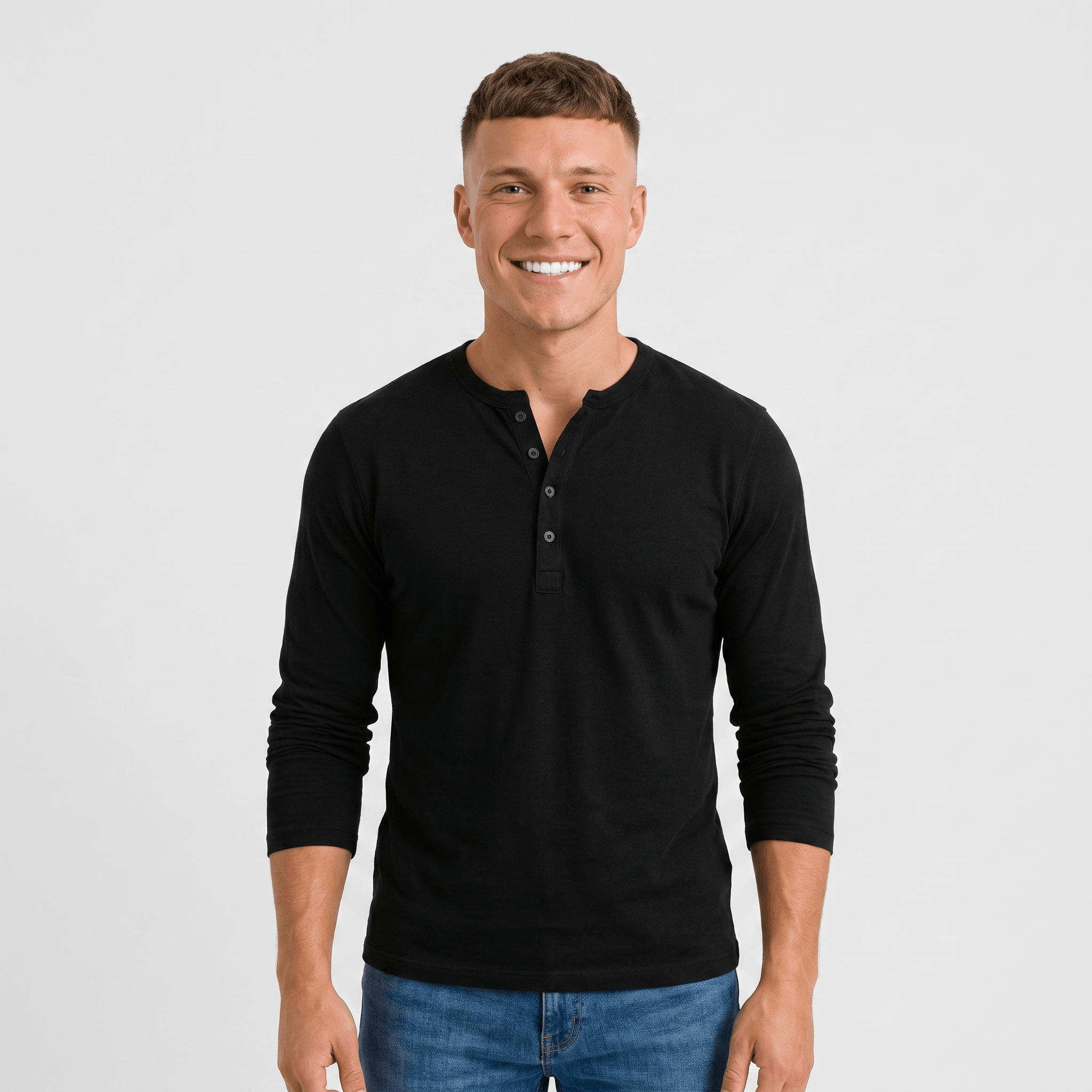 Man wearing a black long-sleeve Henley shirt with a three-button placket, crew neckline, and modern fit.