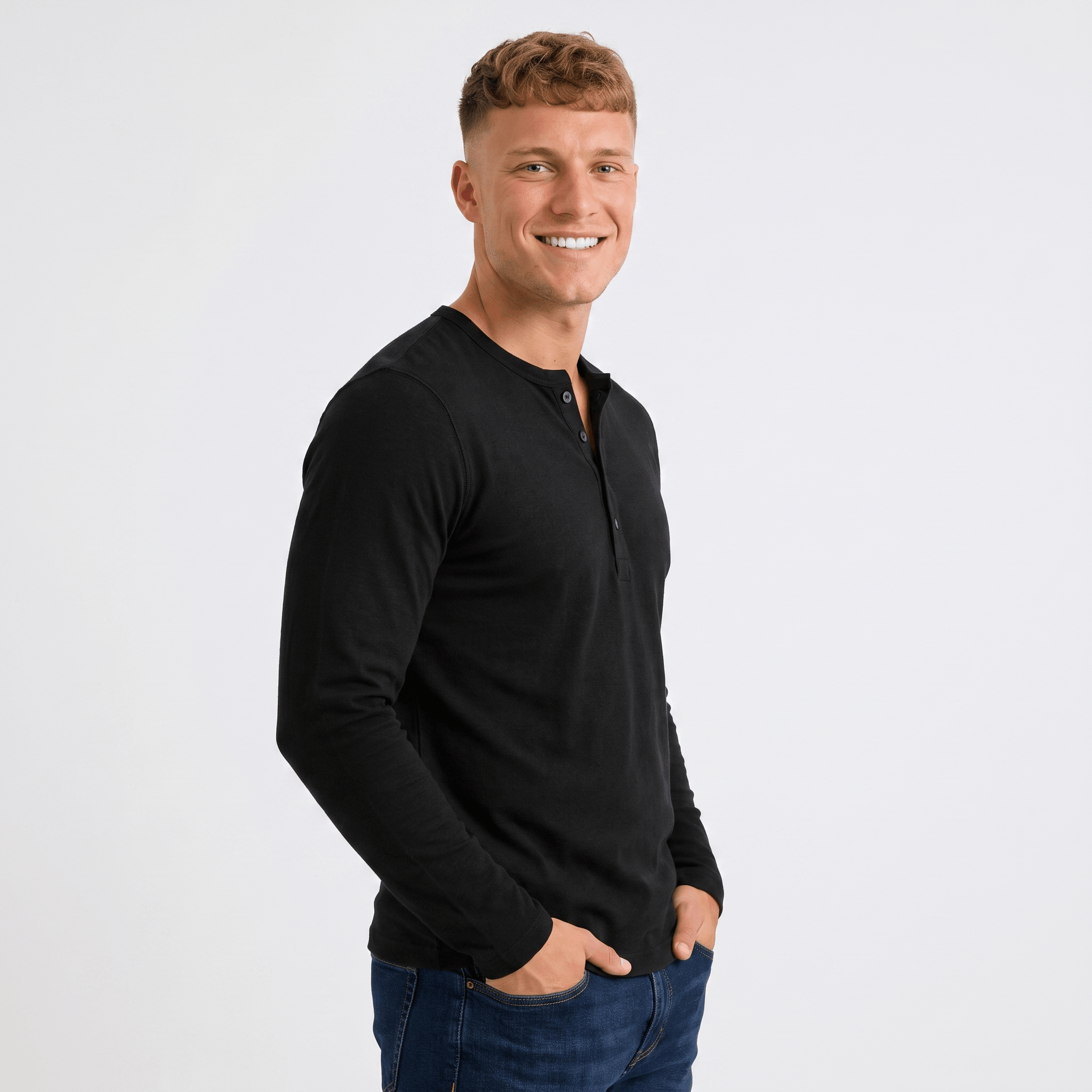 Side view of a man wearing a black long-sleeve Henley shirt with a three-button placket and slim fit.