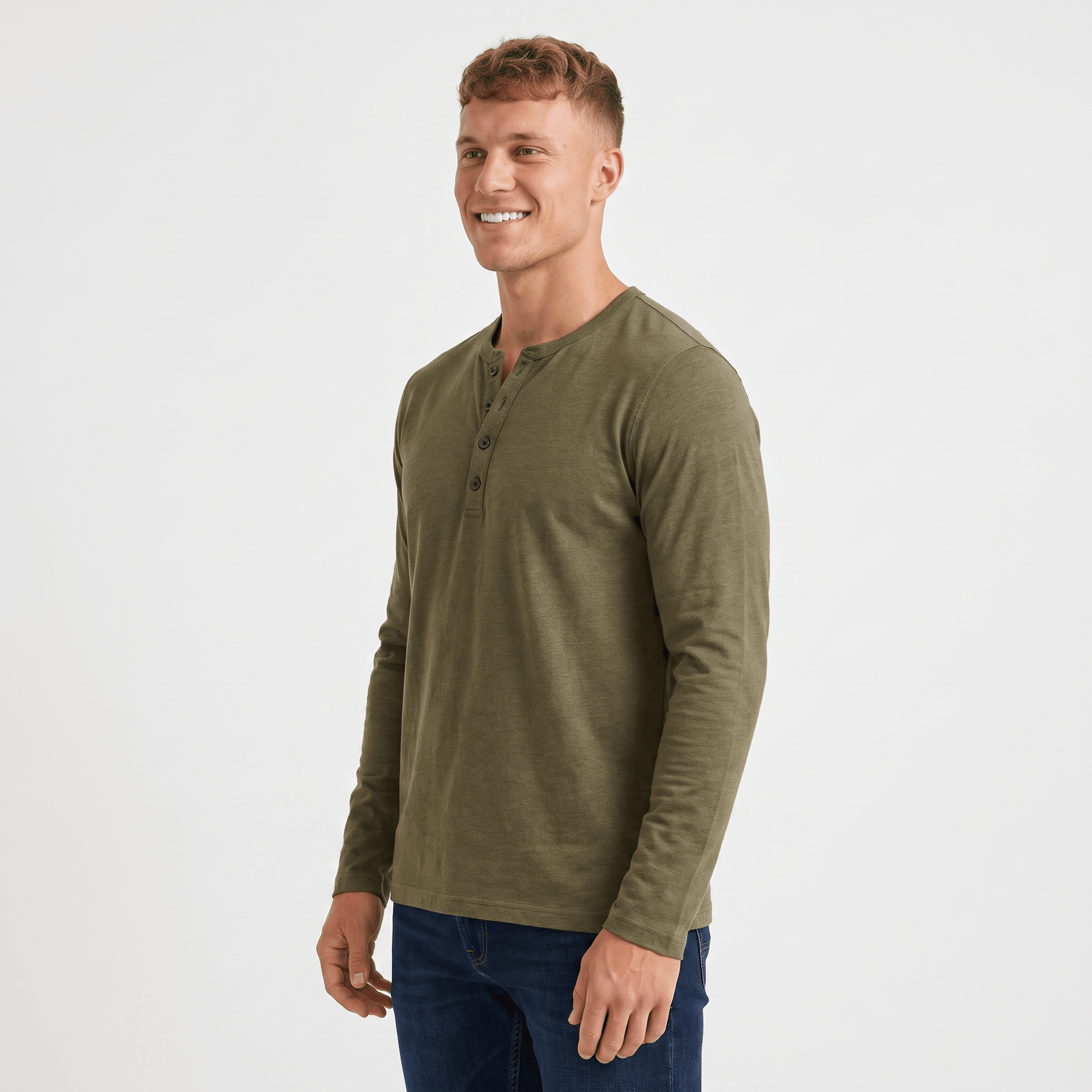 Side view of a man wearing an olive green long-sleeve Henley shirt with a crew neckline and tailored silhouette.