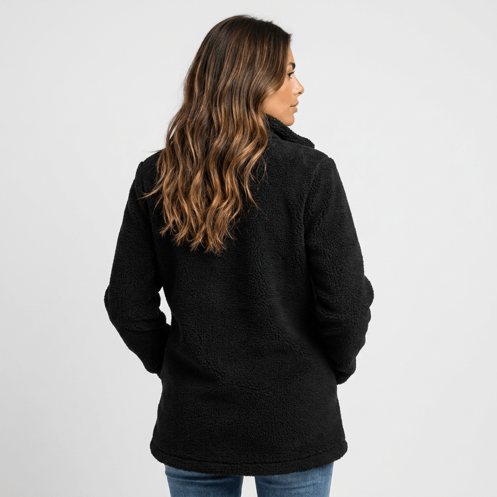 Woman wearing a black textured fleece jacket with a stand collar, front zip closure, and relaxed fit, shown from the back.