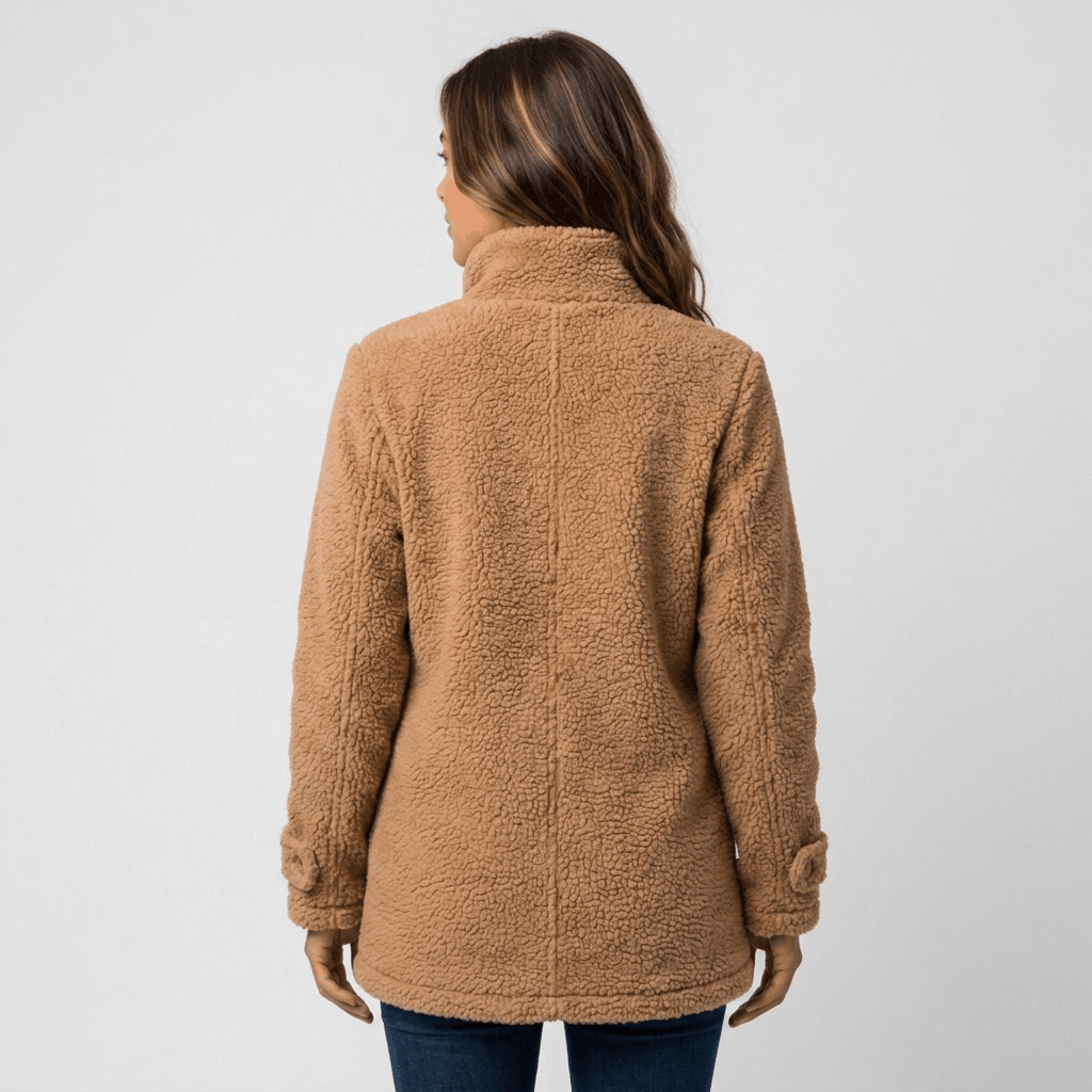 Back view of a woman wearing a camel brown textured fleece jacket with a relaxed silhouette and long sleeves.