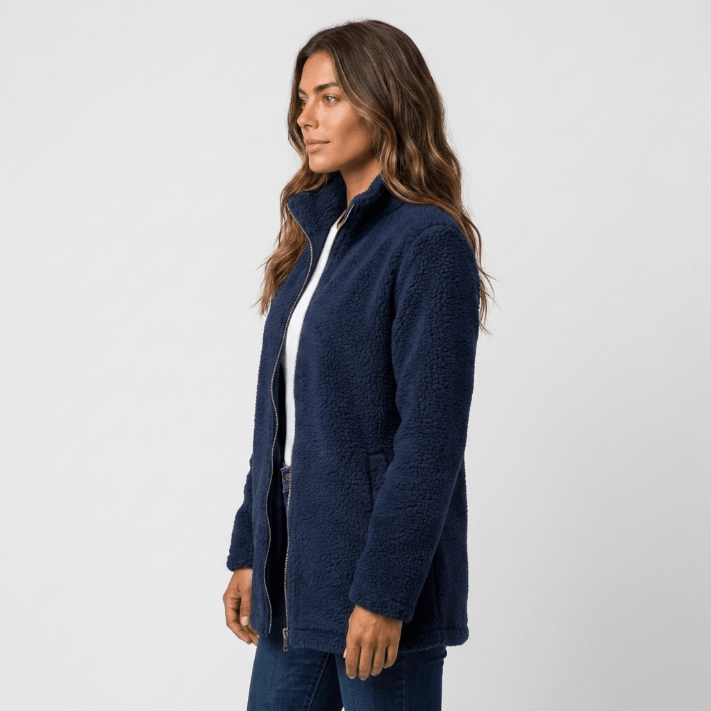 Side view of a woman wearing a navy blue textured fleece jacket with a stand collar and front zip closure.