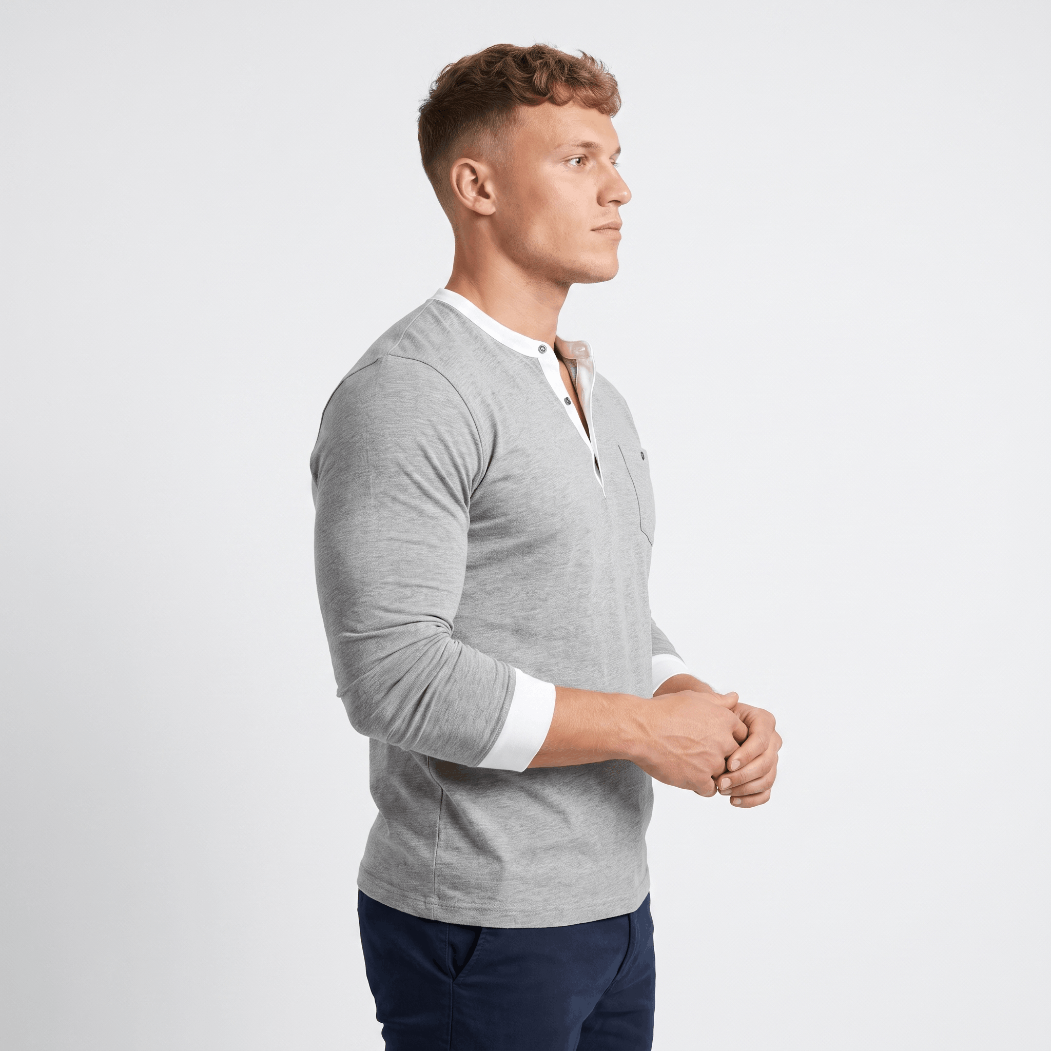 Side view of a man wearing a light gray ribbed quarter-zip knit sweater with a stand collar, long sleeves, and a modern fitted silhouette.