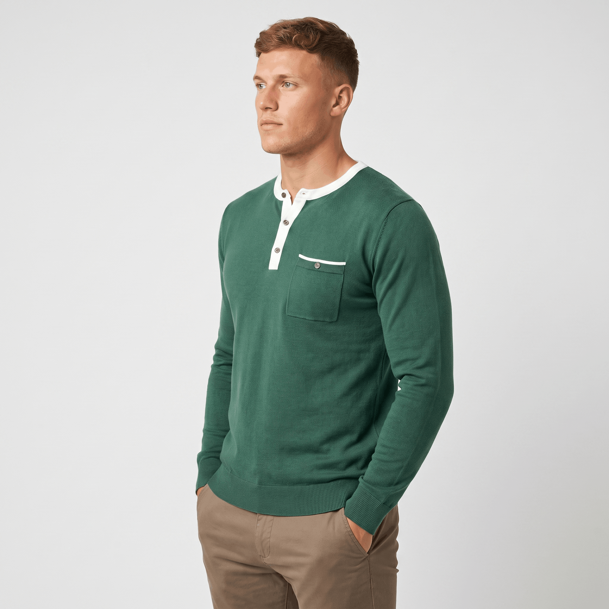 Side view of a man wearing a green long-sleeve Henley sweater featuring a white contrast neckline and tailored silhouette.