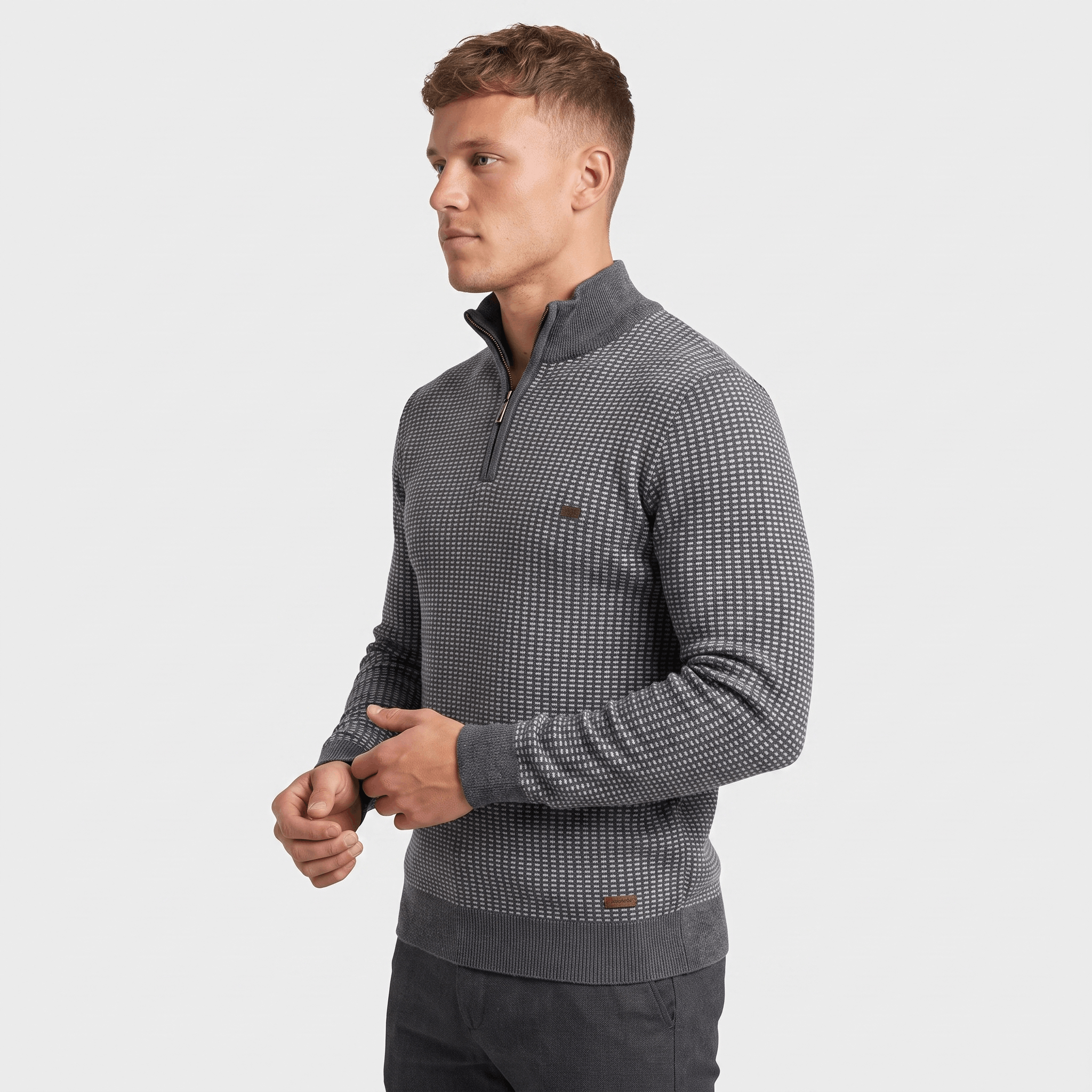 Side view of a man wearing a gray textured quarter-zip sweater featuring a stand collar and geometric knit texture.