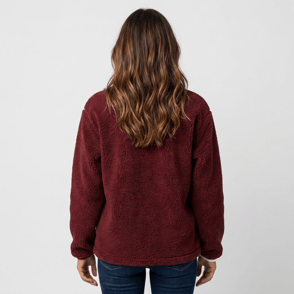 Back view of a woman wearing a burgundy textured fleece jacket with a relaxed fit and long sleeves.