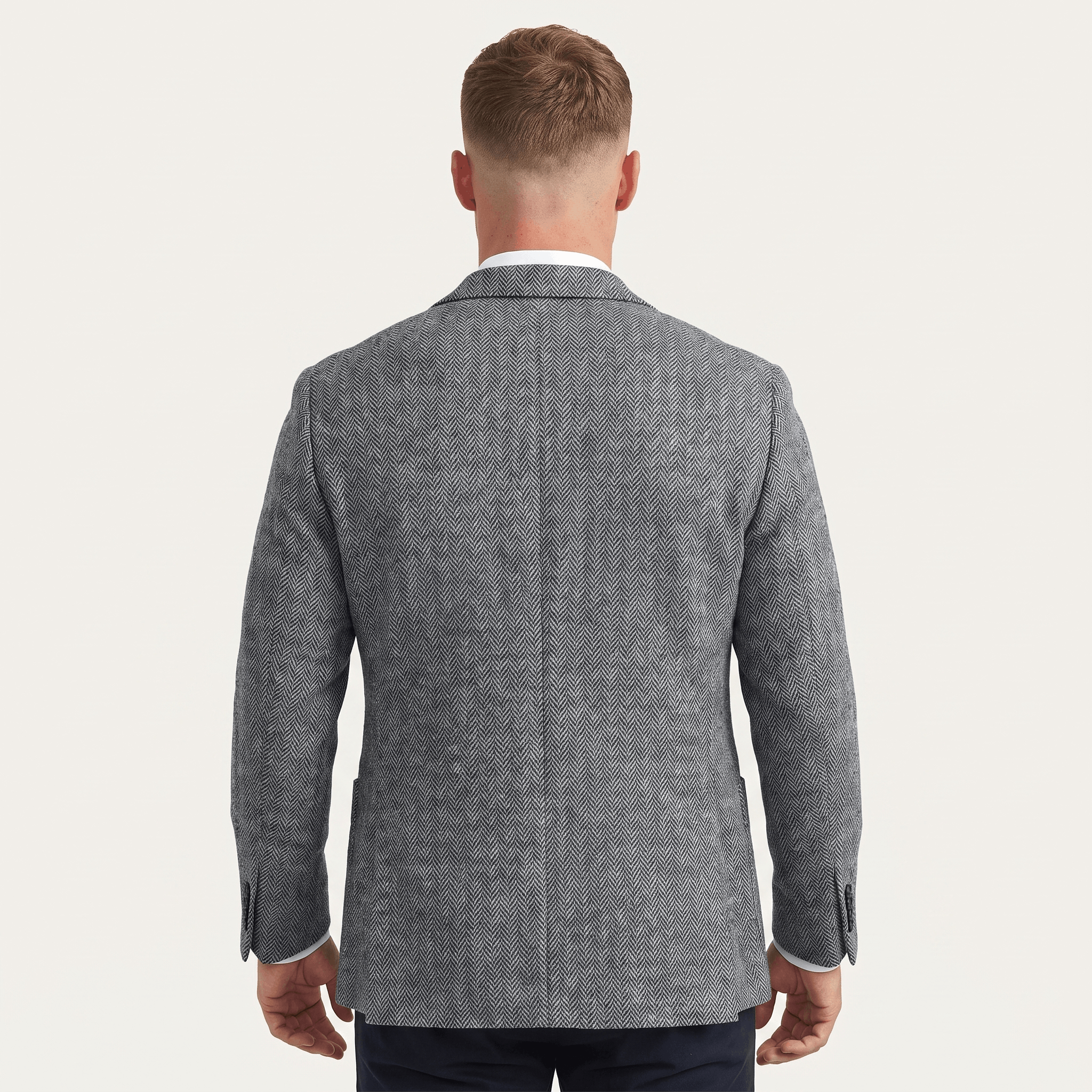 Back view of a men's gray tweed blazer featuring a textured fabric, tailored fit, and classic structured design.