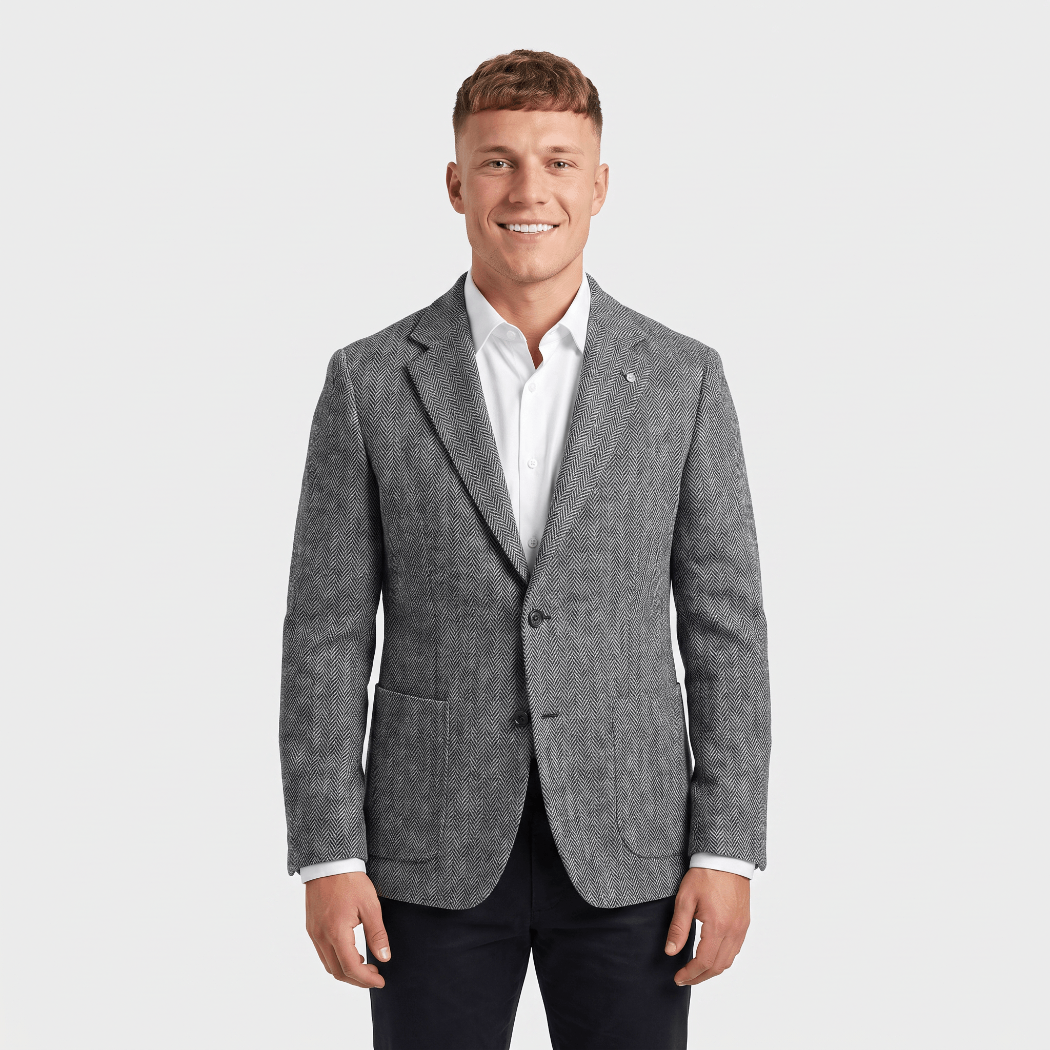 Man wearing a gray textured tweed blazer with a notched lapel, two-button closure, flap pockets, and tailored fit over a white dress shirt and black trousers.