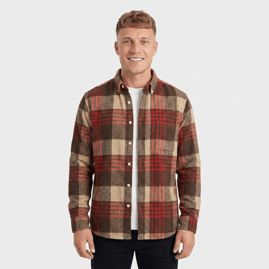 Man wearing a red, brown, and beige plaid overshirt jacket with a button-front closure, chest pockets, and long sleeves.