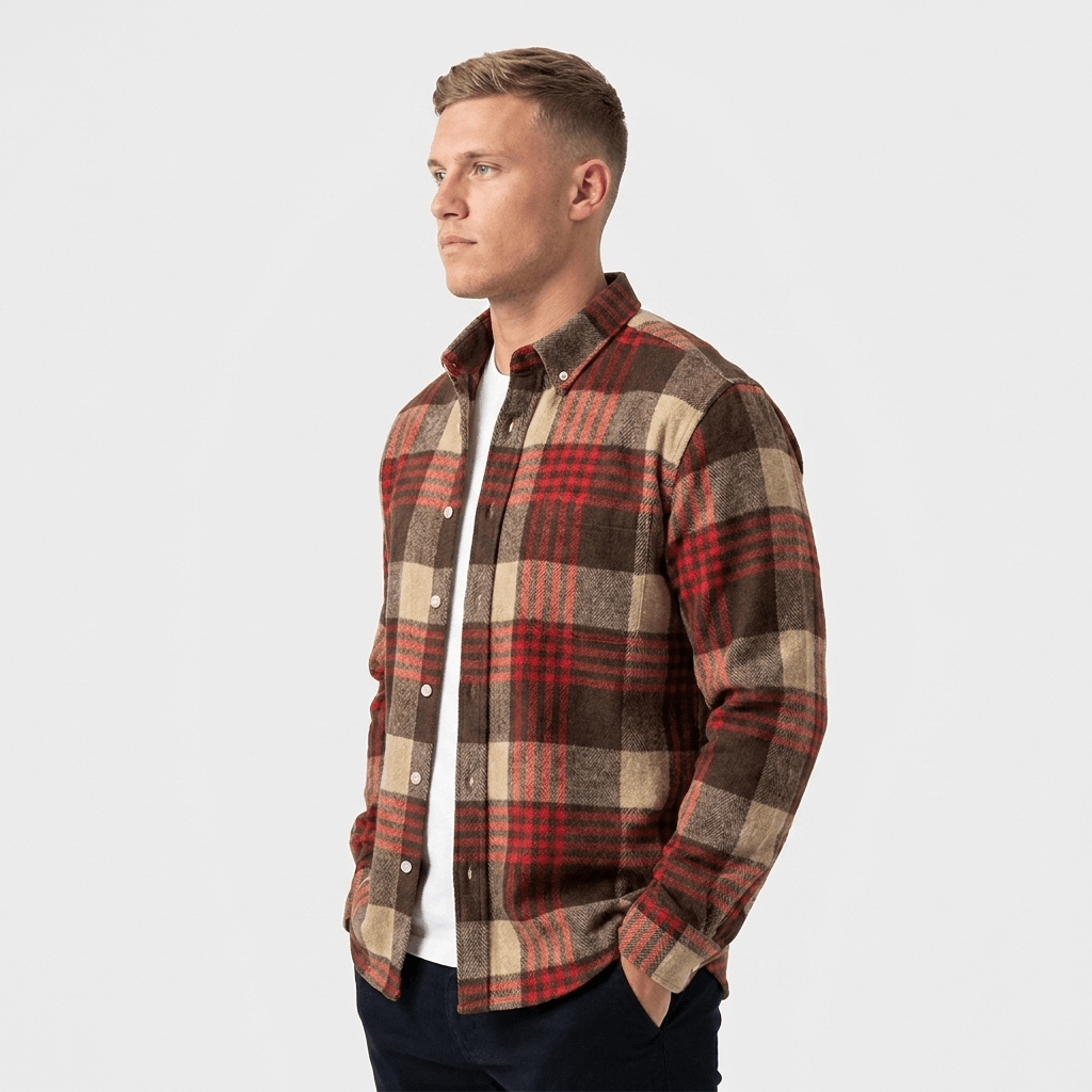 Side view of a man wearing a red, brown, and beige plaid overshirt jacket with a relaxed fit.