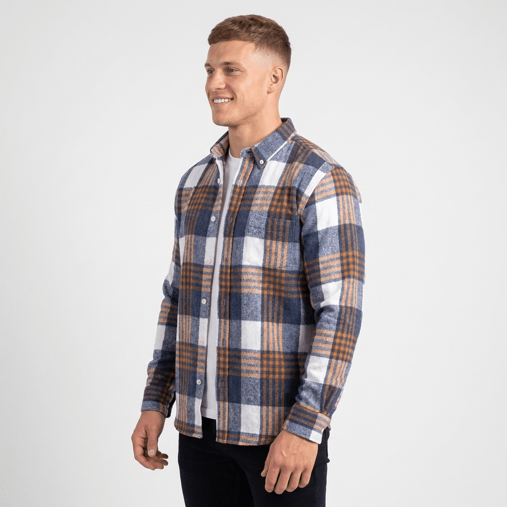 Side view of a man wearing a blue, white, and brown plaid overshirt jacket with a relaxed fit and button-front closure.