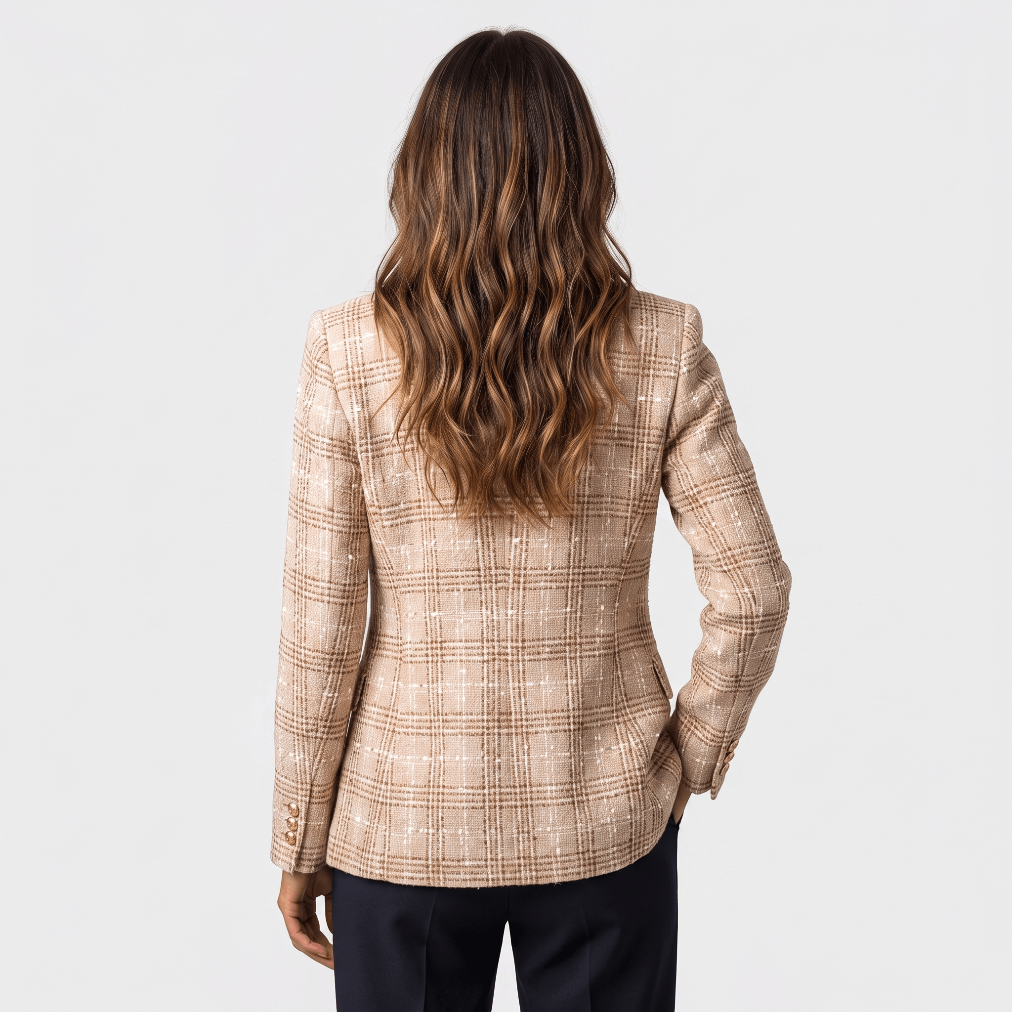 Back view of a woman wearing a beige plaid tweed blazer with a tailored fit and long sleeves.