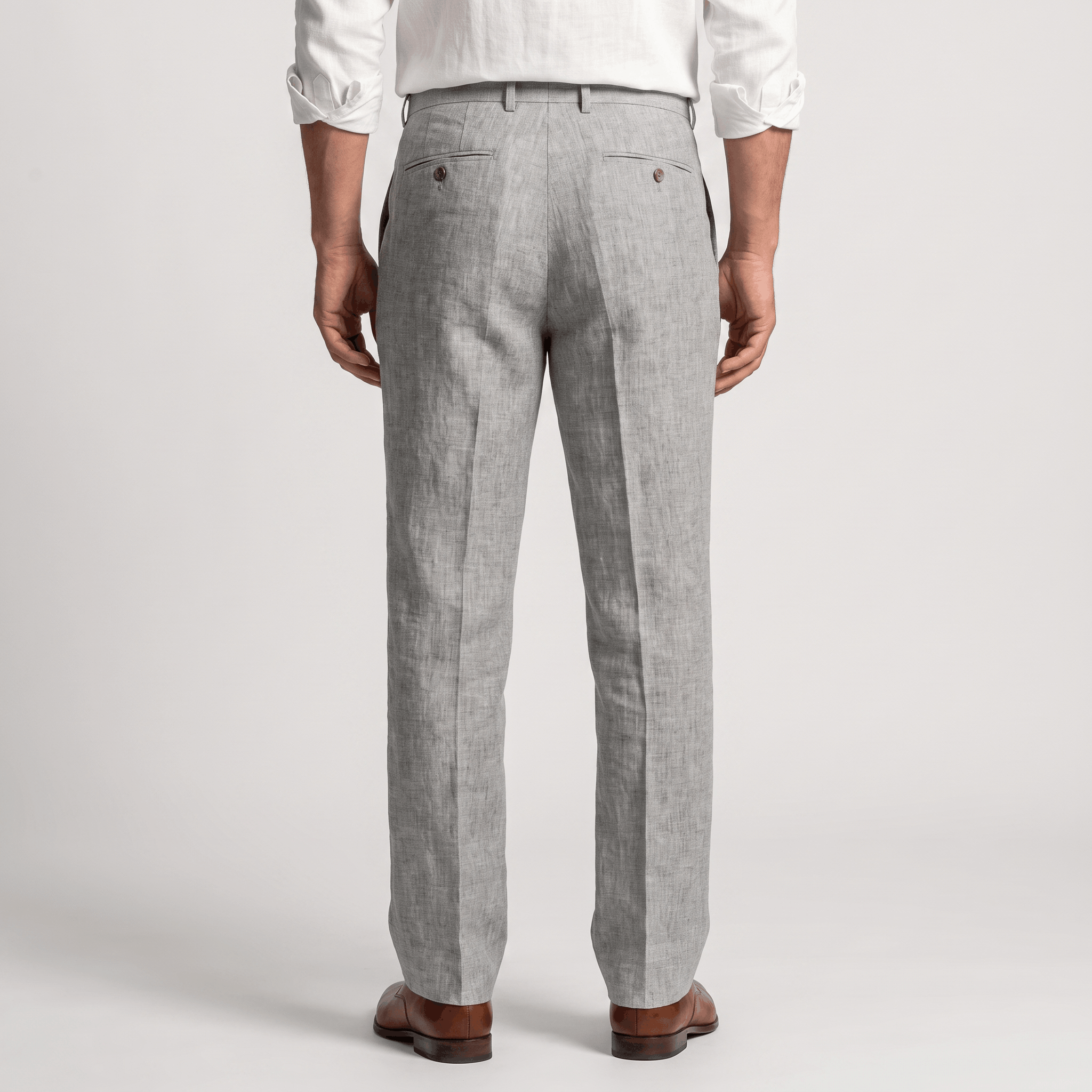 Back view of men's light gray linen pleated trousers with front pleats, belt loops, and a classic tailored fit.