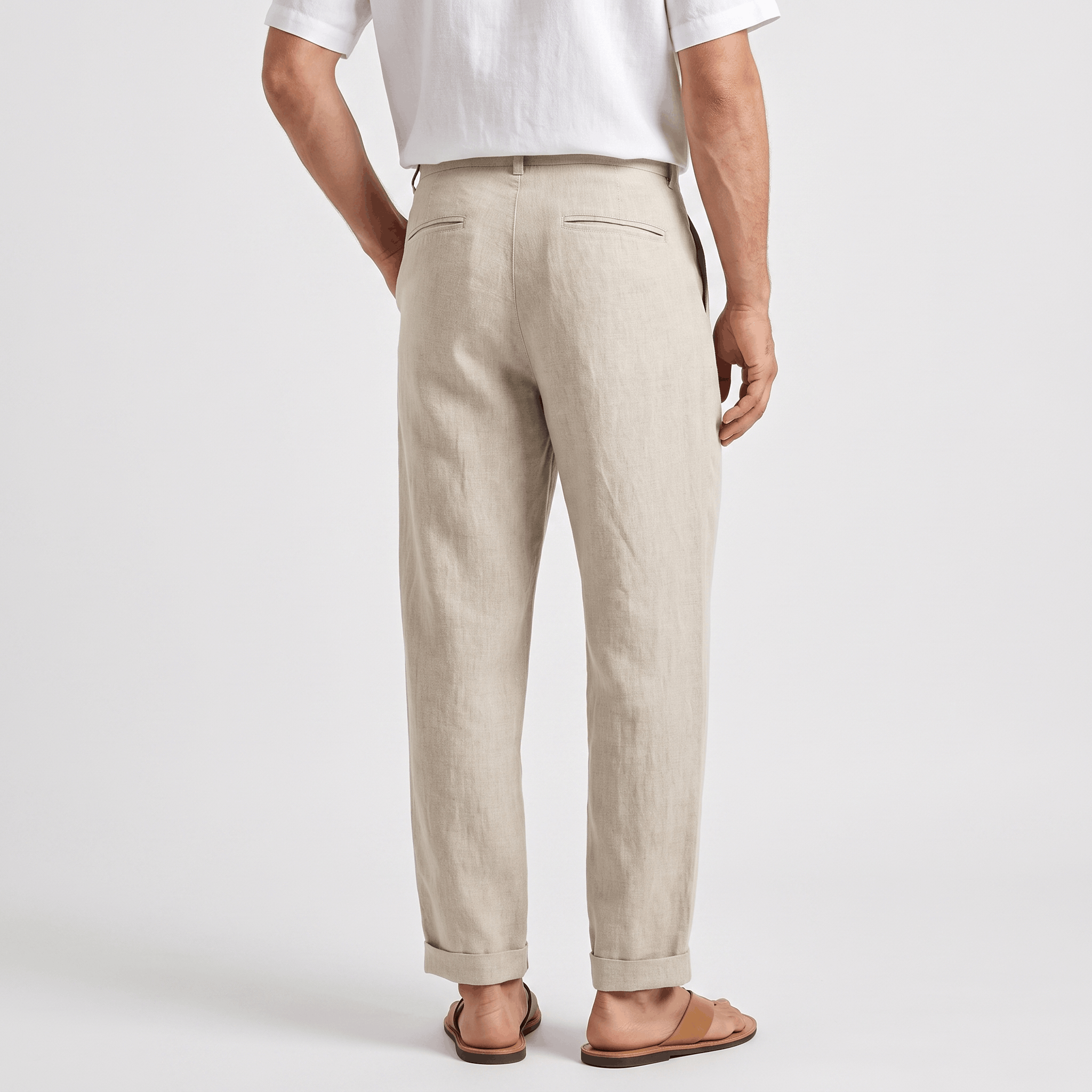 Back view of men's beige linen pants featuring a straight-leg silhouette, belt loops, and breathable linen fabric.