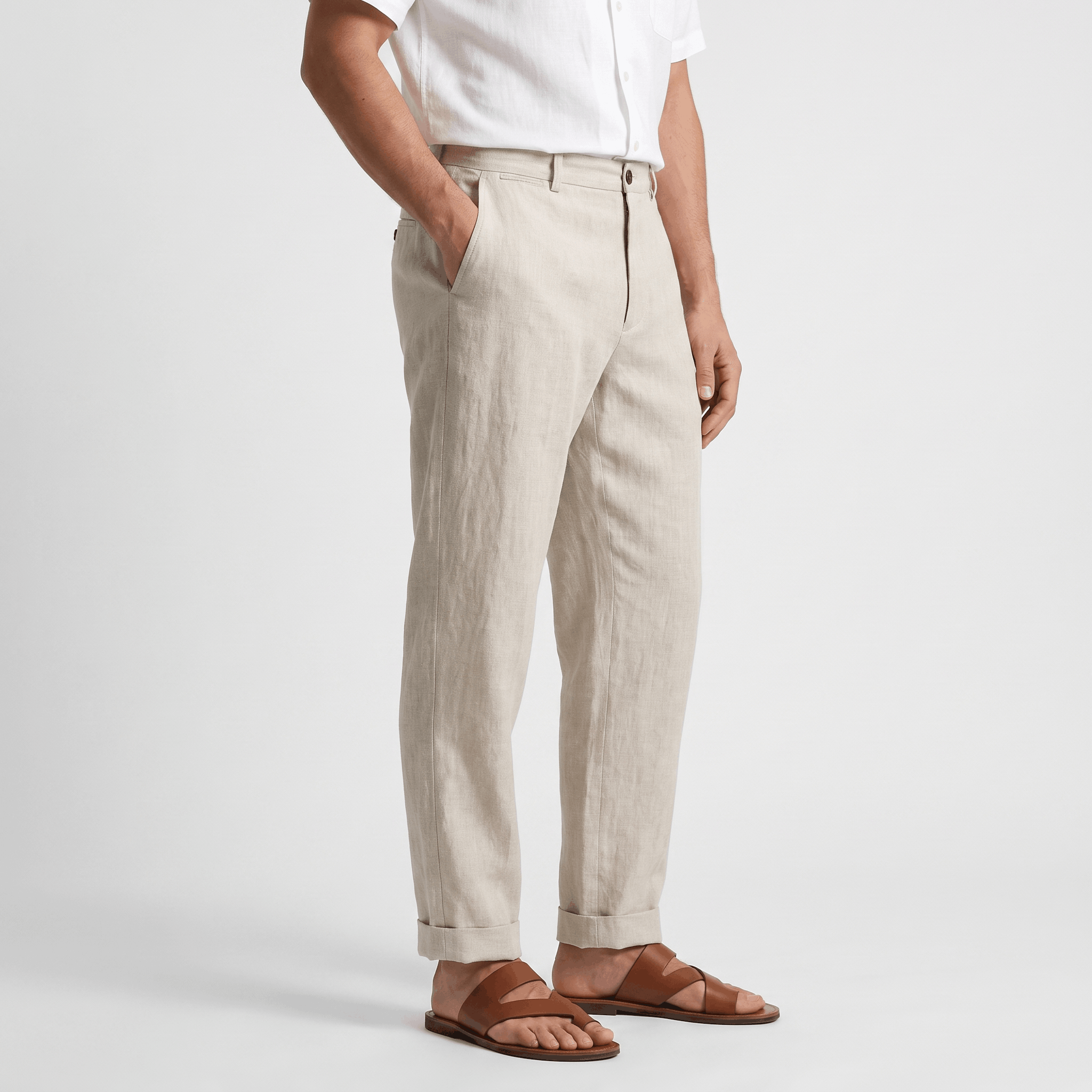 Side view of men's beige linen pants with a tailored straight-leg fit, button closure, and lightweight linen construction.