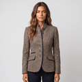 Front view of a woman wearing a brown tweed blazer with navy trim, button closure, flap pockets, and fitted silhouette.