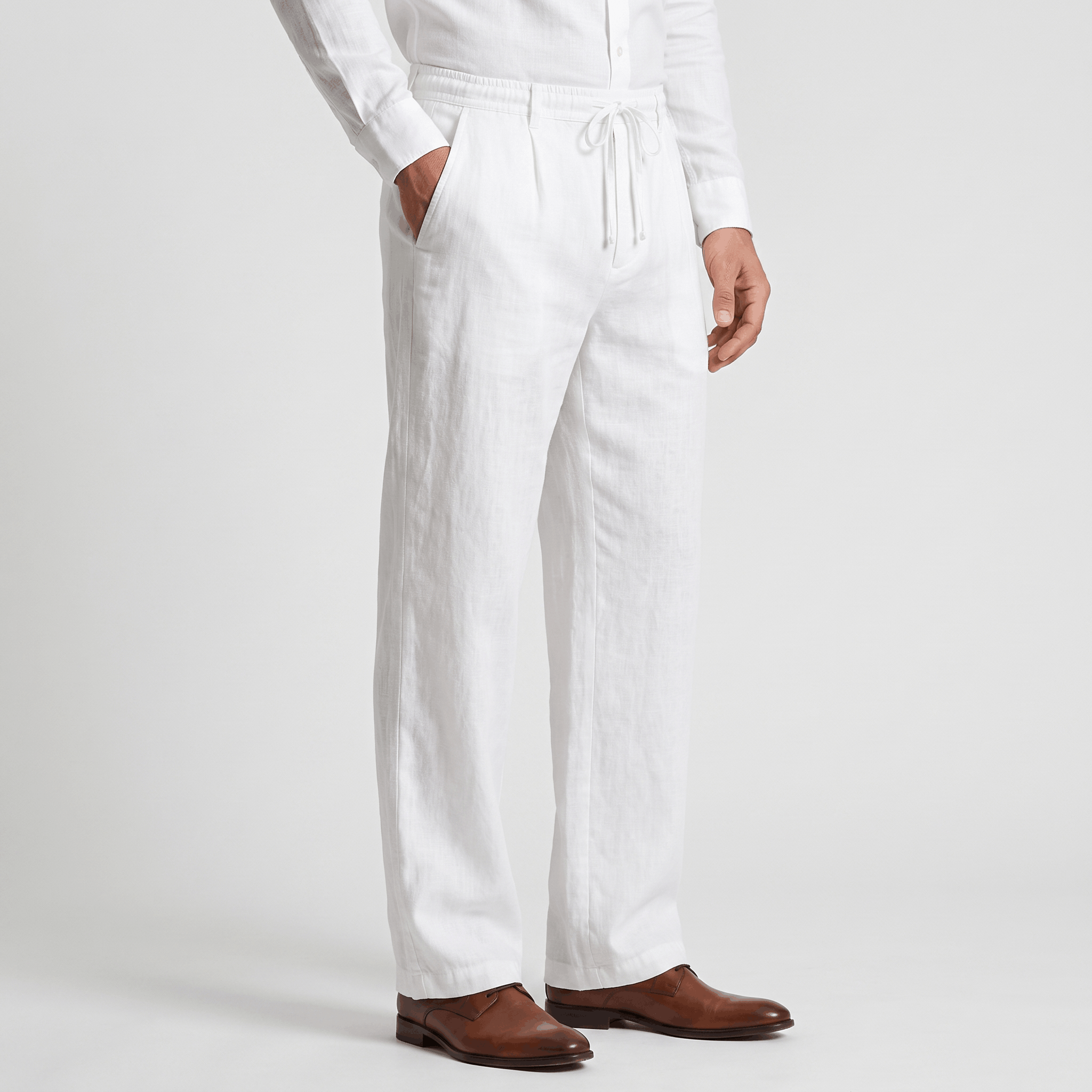 Side view of men's white linen drawstring pants featuring an elastic waistband, relaxed straight-leg silhouette, and breathable linen fabric.