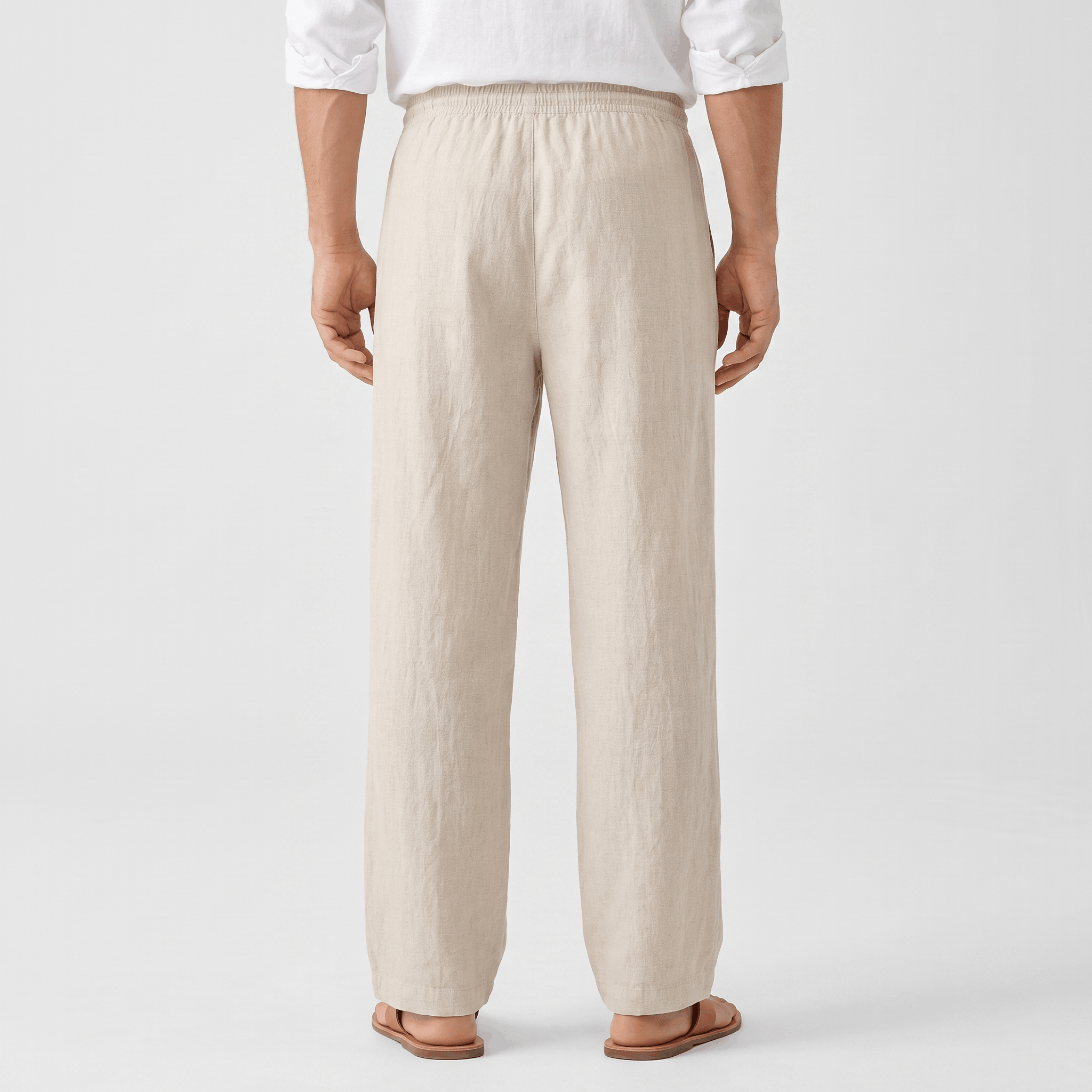 Back view of men's cream linen drawstring pants with an elastic waistband and classic straight-leg silhouette.