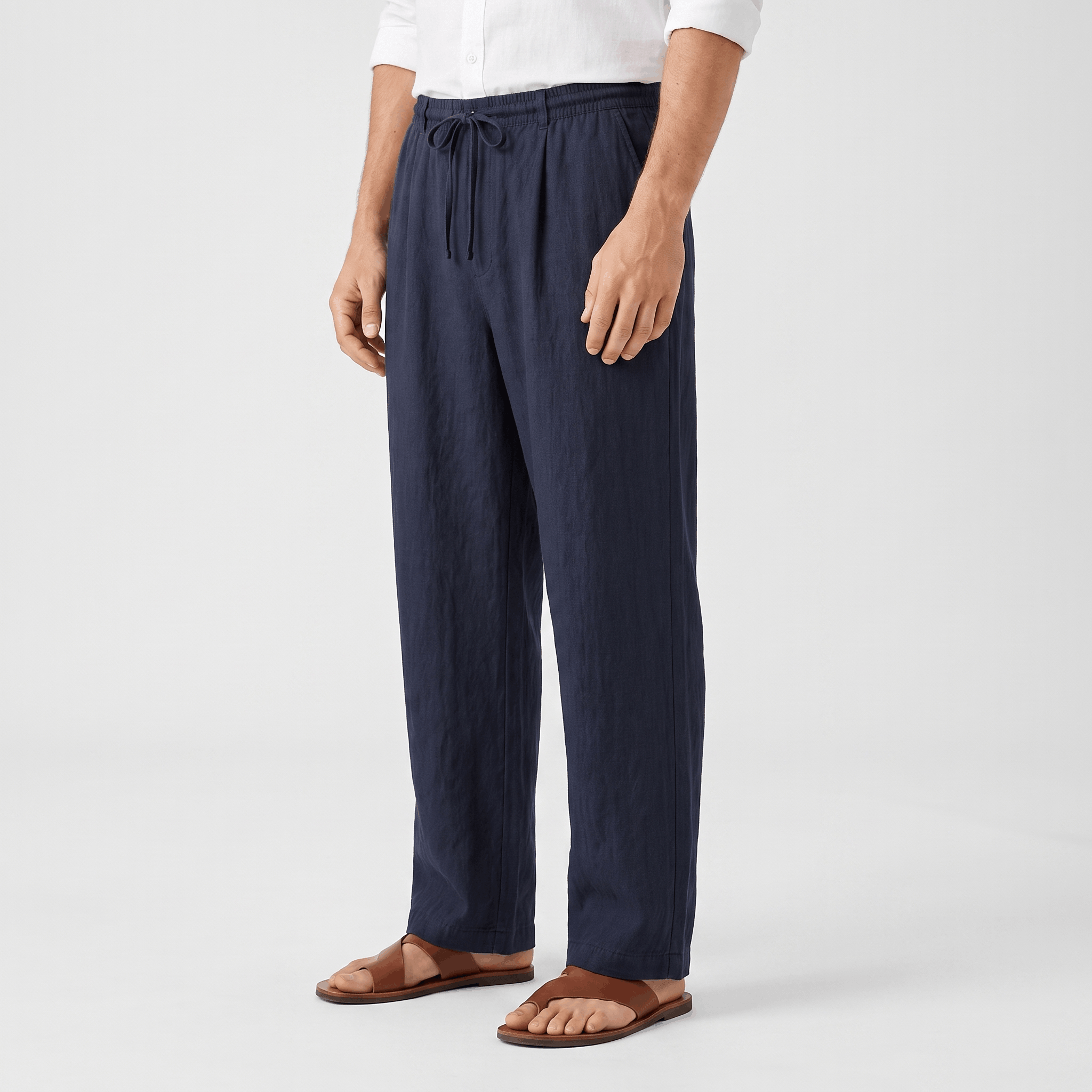 Side view of men's navy linen drawstring pants featuring a relaxed silhouette, adjustable drawstring, and side pockets.