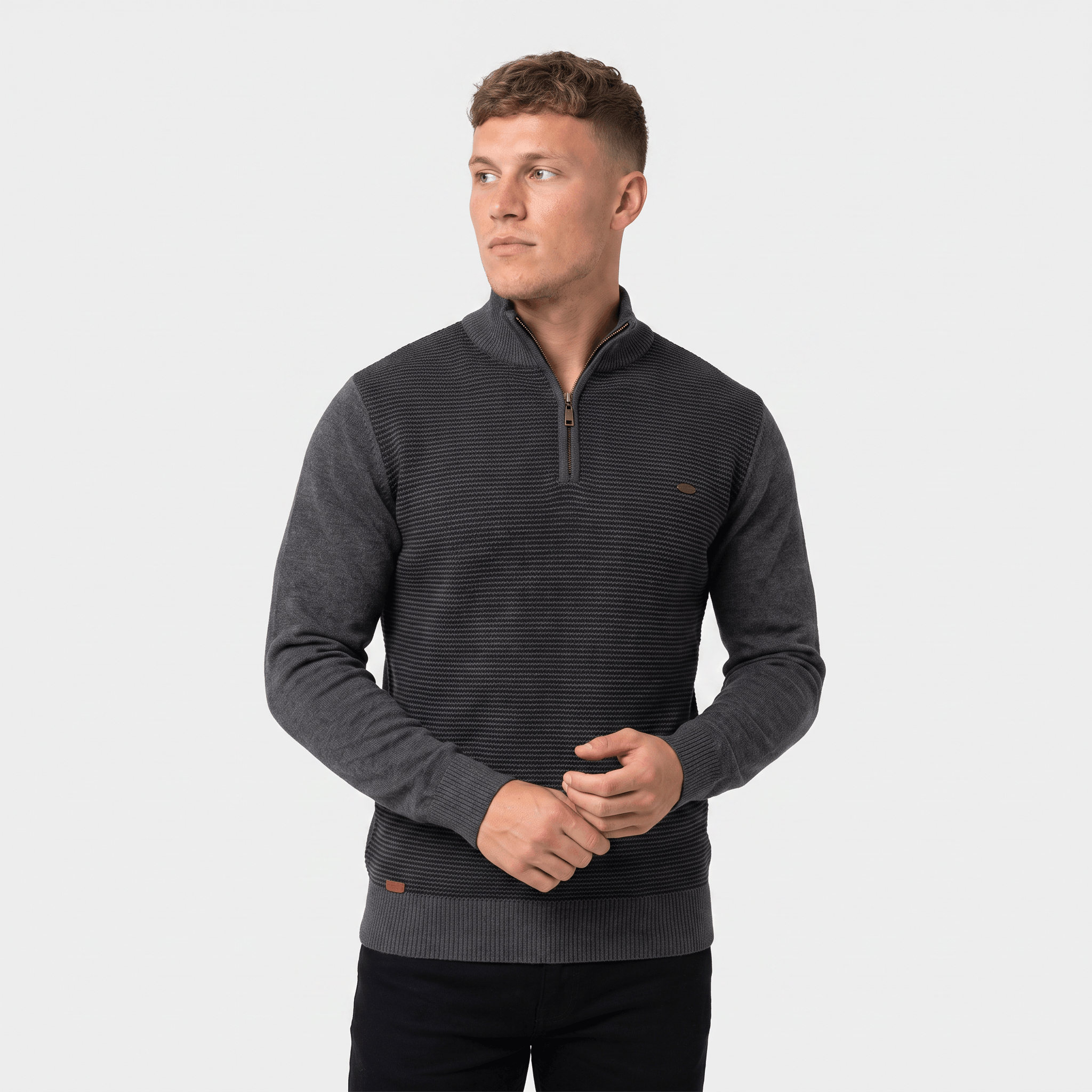 Man wearing a charcoal ribbed quarter-zip knit sweater with a stand collar, long sleeves, and a modern slim fit.