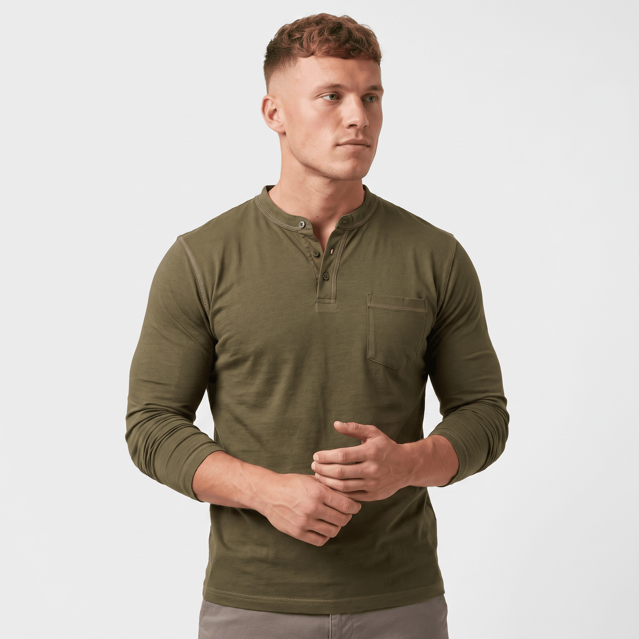 Side view of a man wearing an olive green long-sleeve Henley shirt featuring a three-button neckline, chest pocket, and tailored silhouette.